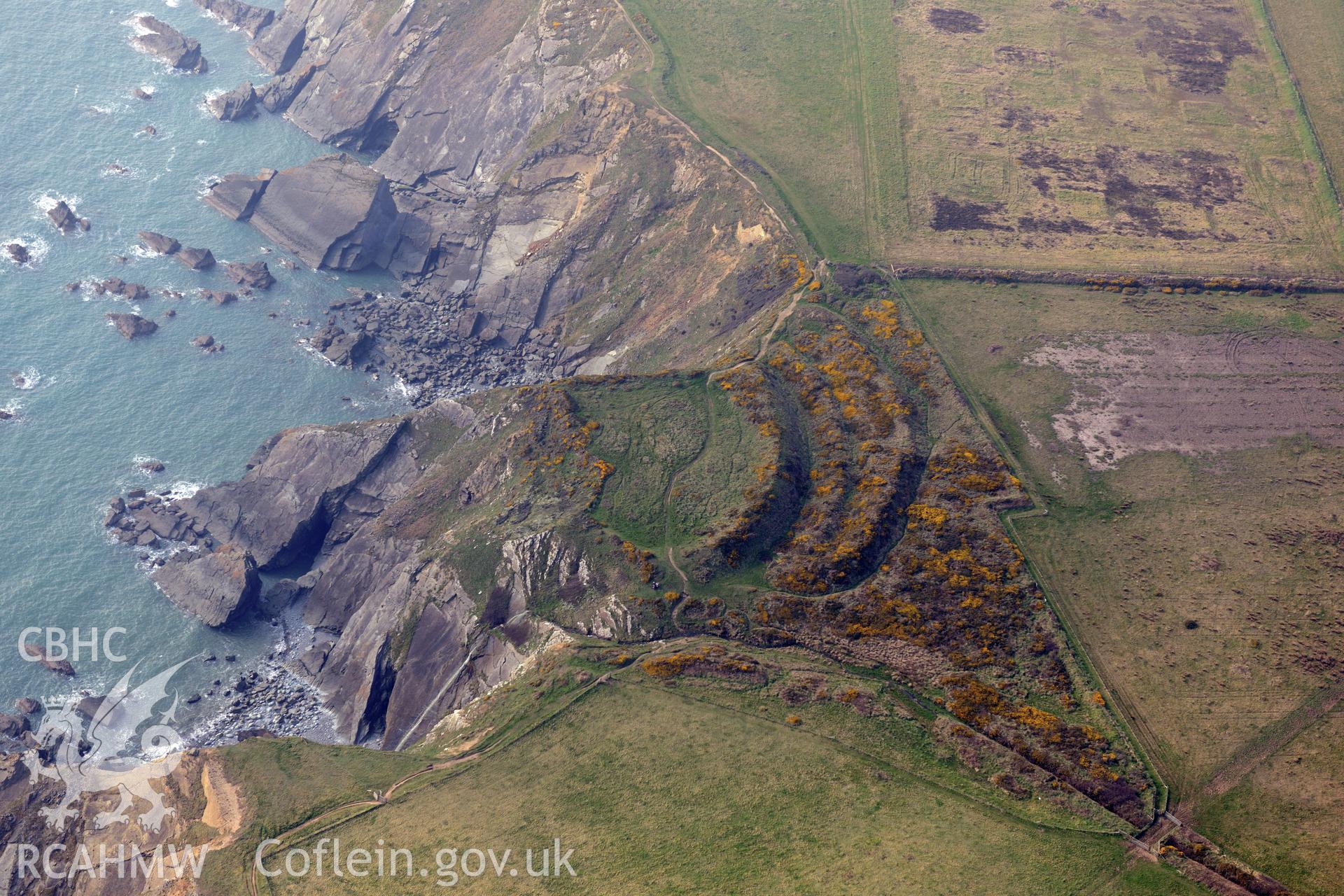 Aerial photography of Watery Bay Rath taken on 27th March 2017. Baseline aerial reconnaissance survey for the CHERISH Project. ? Crown: CHERISH PROJECT 2017. Produced with EU funds through the Ireland Wales Co-operation Programme 2014-2020. All material made freely available through the Open Government Licence.