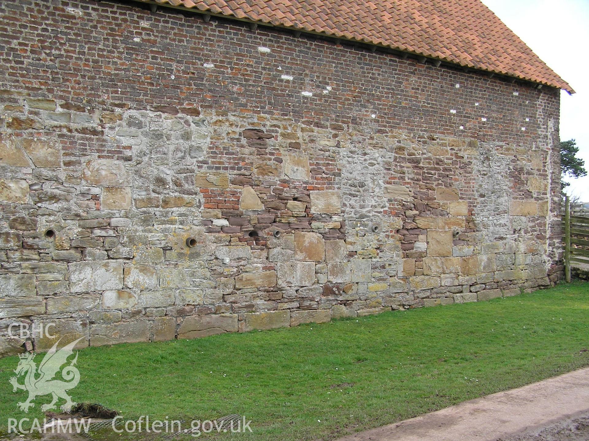 Colour photo showing the south end of the west elevation of the cowhouse, taken by John Wheelock and donated as a condition of planning consent.