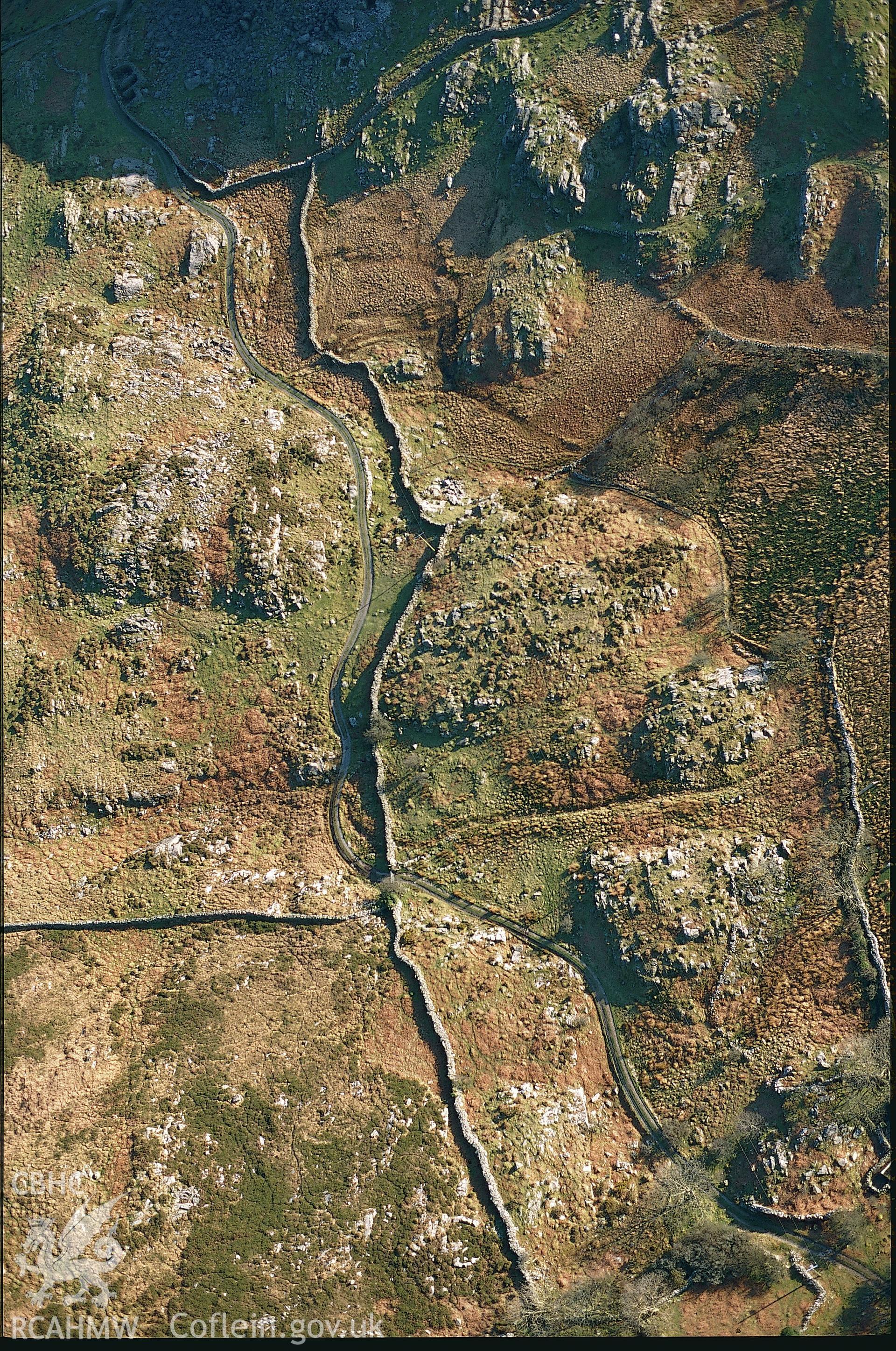 RCAHMW colour slide oblique aerial photograph of the hut circle at Gellfawr, Barmouth, taken on 17/03/1999 by Toby Driver