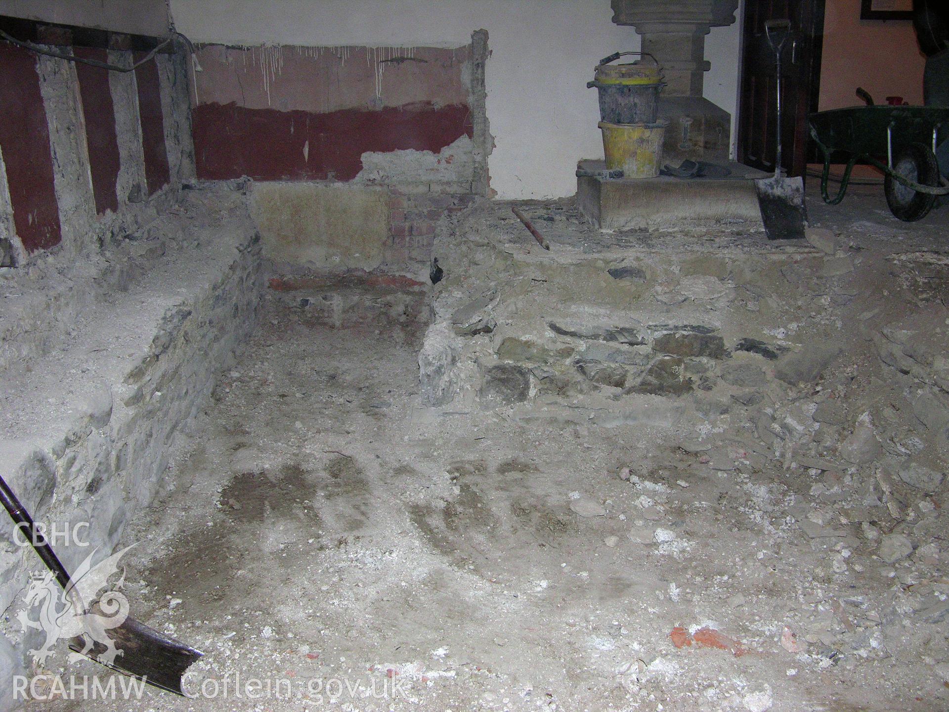 Digital colour photograph showing view of exposed foundations around font - part of an archaeological watching brief for St Michaels Church, Trefeglwys, Powys (CAP Report 602) by Chris E. Smith.