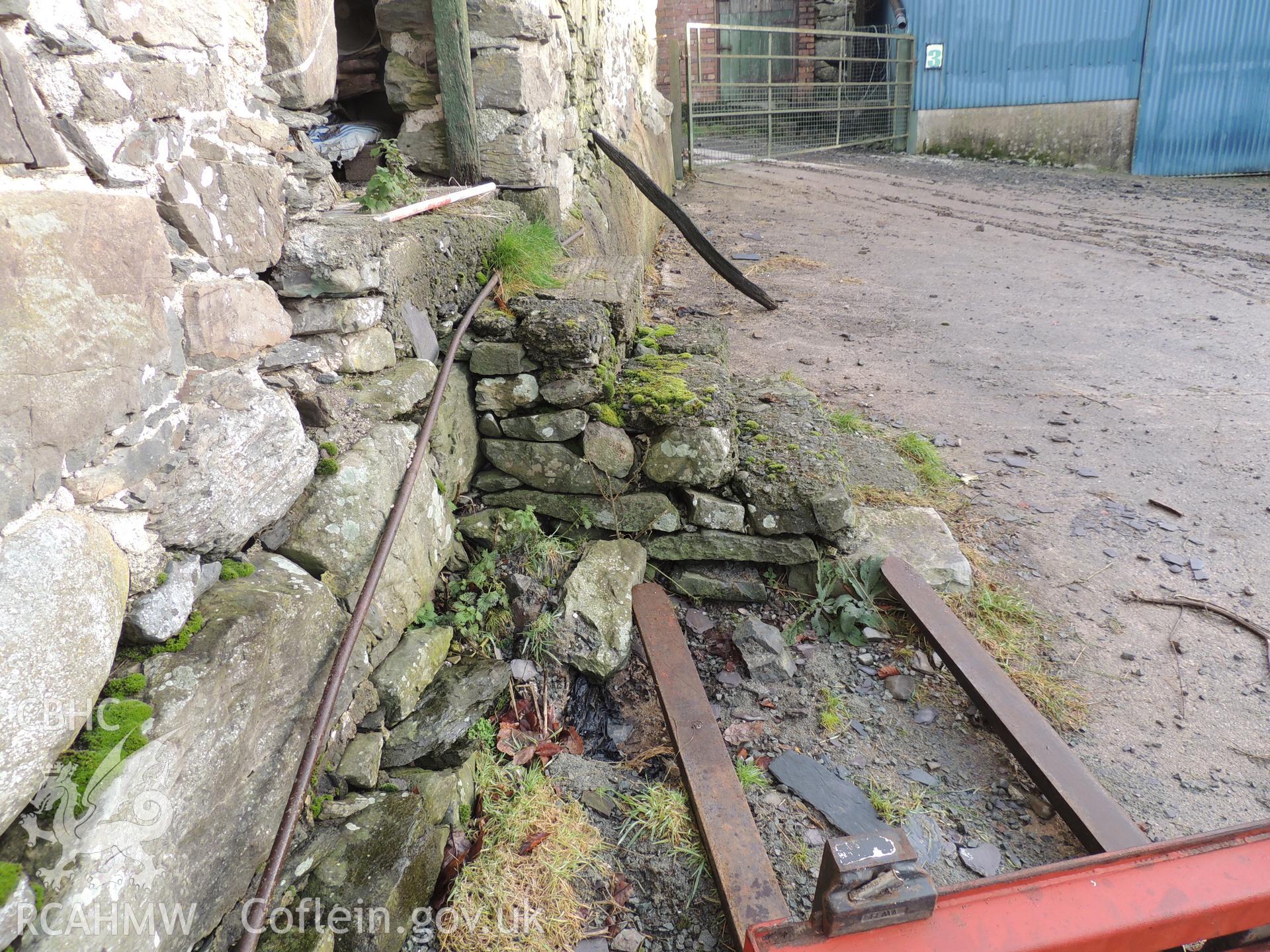 Detailed view of steps with concrete layer, looking east. Photograph taken as part of archaeological building survey conducted at Bryn Gwylan Threshing Barn, Llangernyw, Conwy, carried out by Archaeology Wales, 2017-2018. Report no. 1640. Project no. 2578.