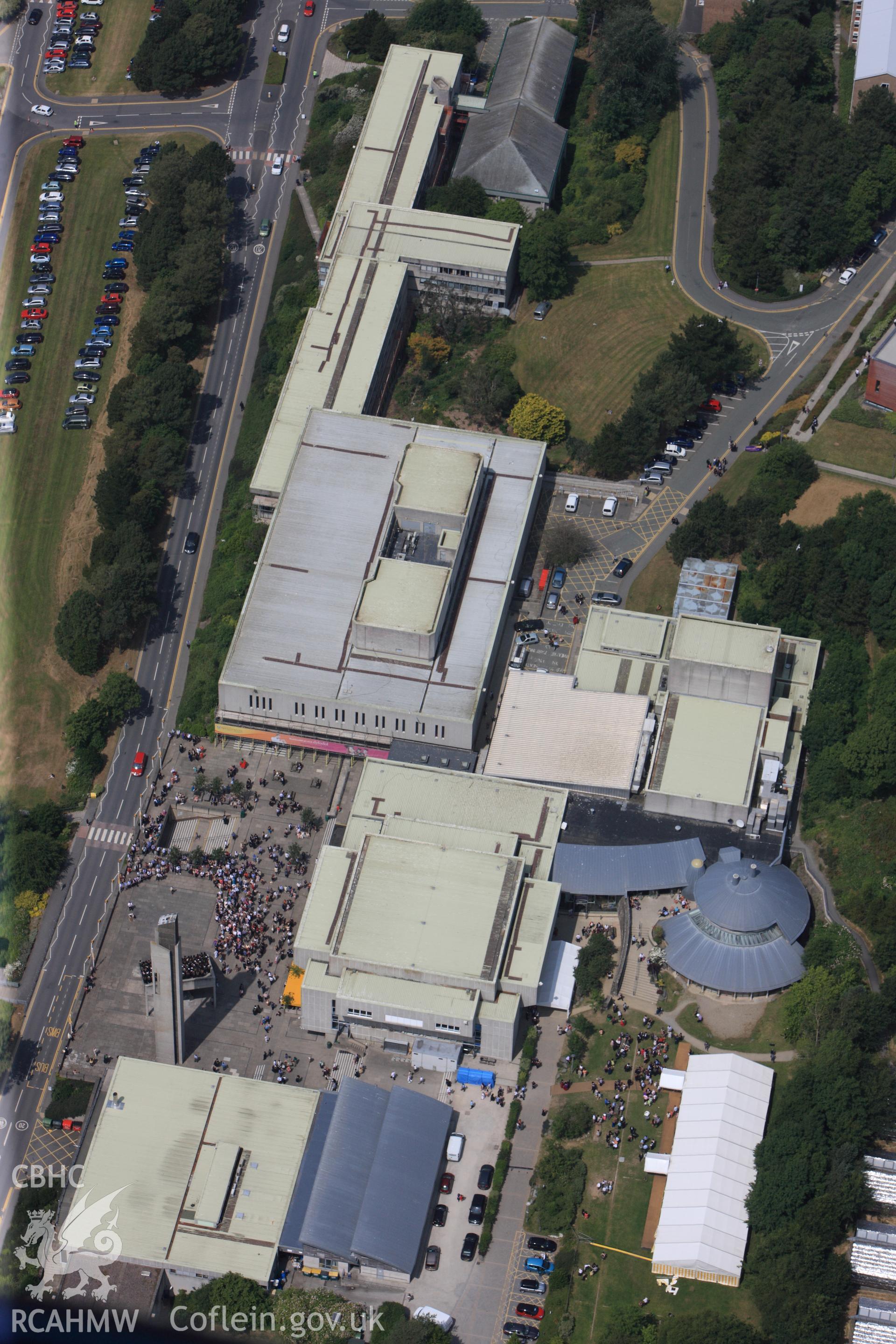 Aberystwyth Arts Centre on Graduation Day. Oblique aerial photograph taken during the Royal Commission?s programme of archaeological aerial reconnaissance by Toby Driver on  12th July 2013.