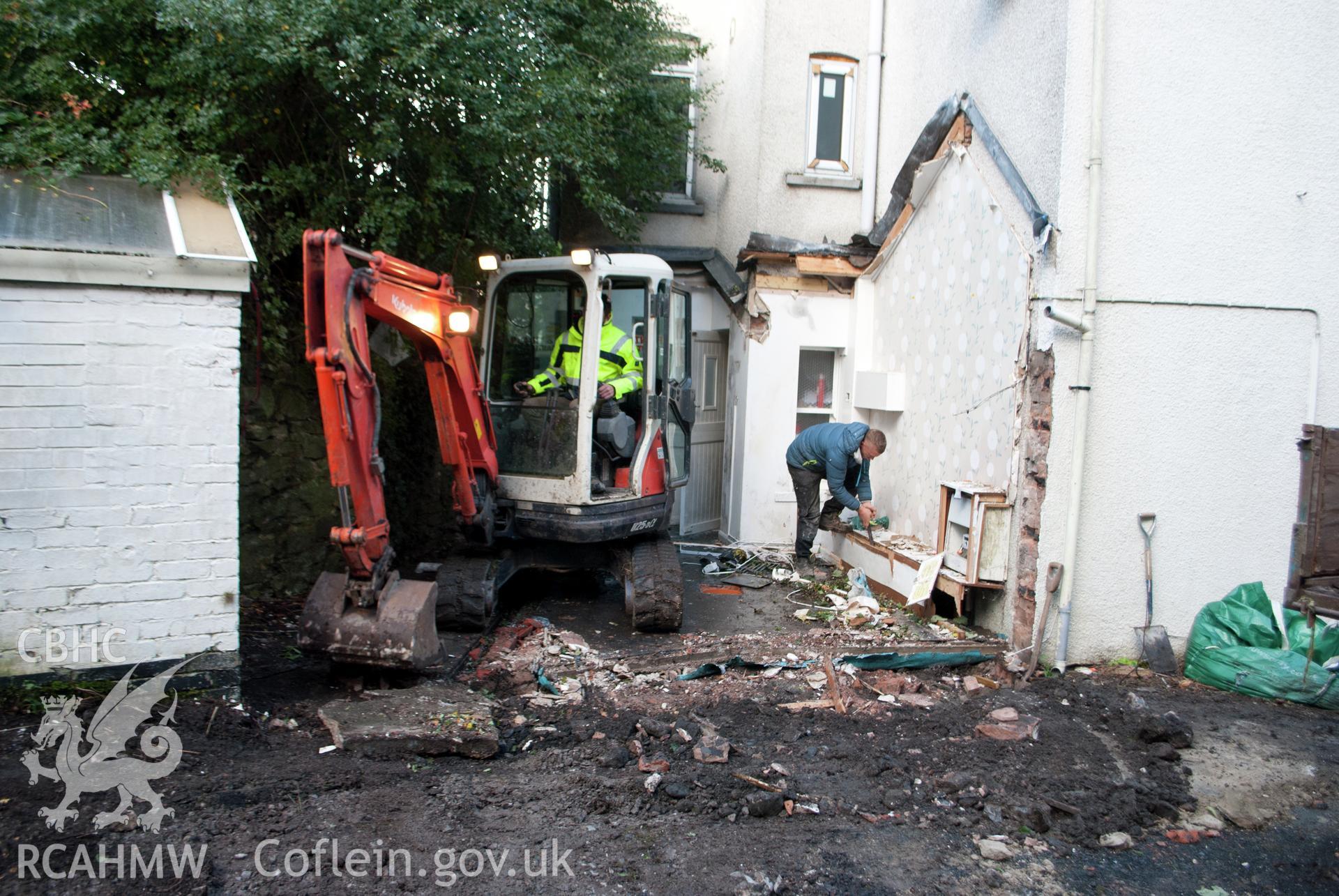 General view from the east showing working shot of the 3-tonne machine working in the conservatory  area at Gwynle, Y Bala. Photographed during archaeological watching brief conducted by Gwynedd Archaeological Trust on 21 September 2018. Project no. G2573.