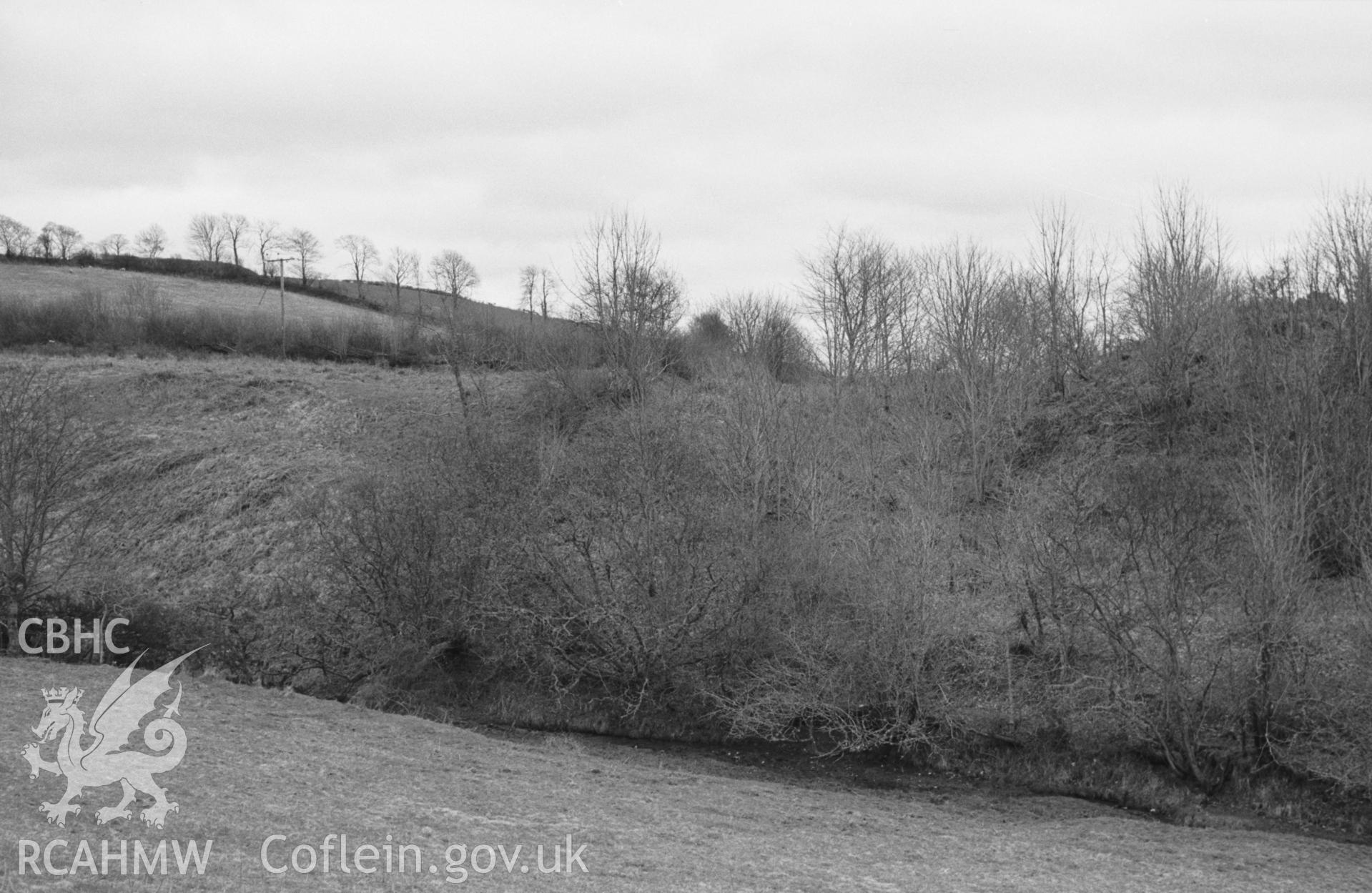 Digital copy of a black and white negative showing Castell Hywel motte, west of Lampeter. Photographed by Arthur O. Chater in April 1965 from Grid Reference SN 4405 4773, looking south. (Panorama 2 0f 2 photographs)