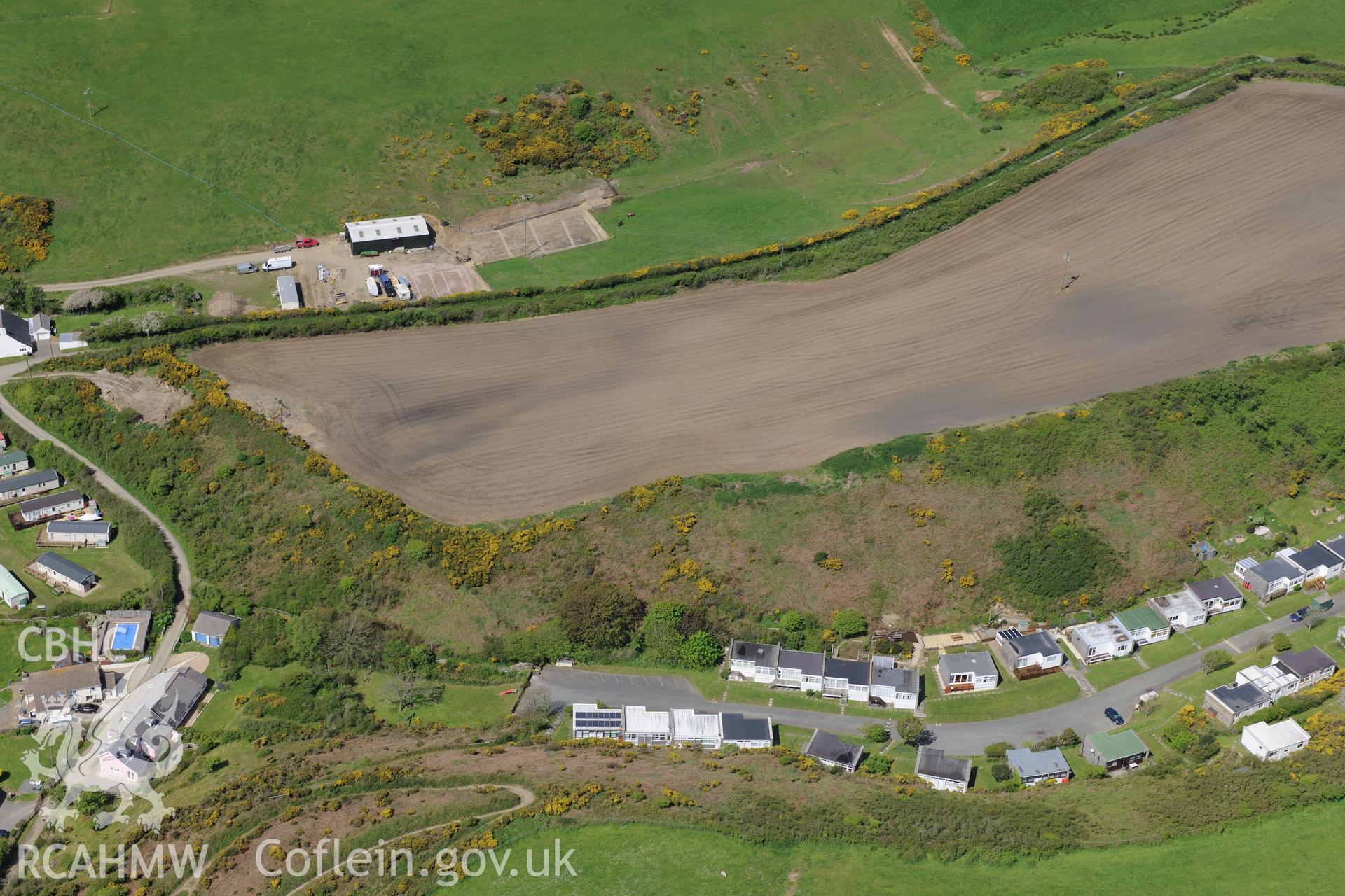 The village of Nolton Haven with soilmarks in field at Nolton Haven farm above.  Oblique aerial photograph taken during the Royal Commission's programme of archaeological aerial reconnaissance by Toby Driver on 13th May 2015.