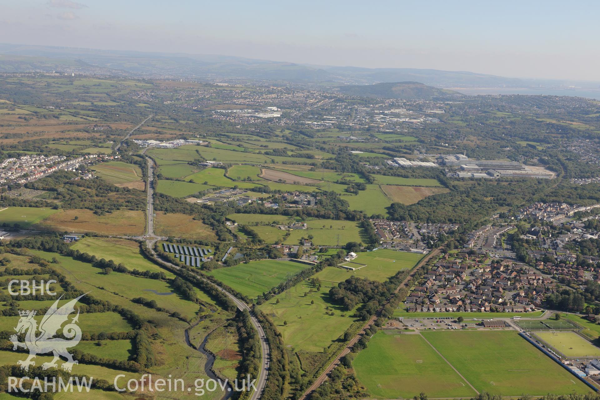 Roman military enclosure on Stafford Common (left of the roundabout), with Cockett processing works and Ici metal works beyond, in Gowerton, Swansea. Oblique aerial photograph taken during the Royal Commission's programme of archaeological aerial reconnaissance by Toby Driver on 30th September 2015.