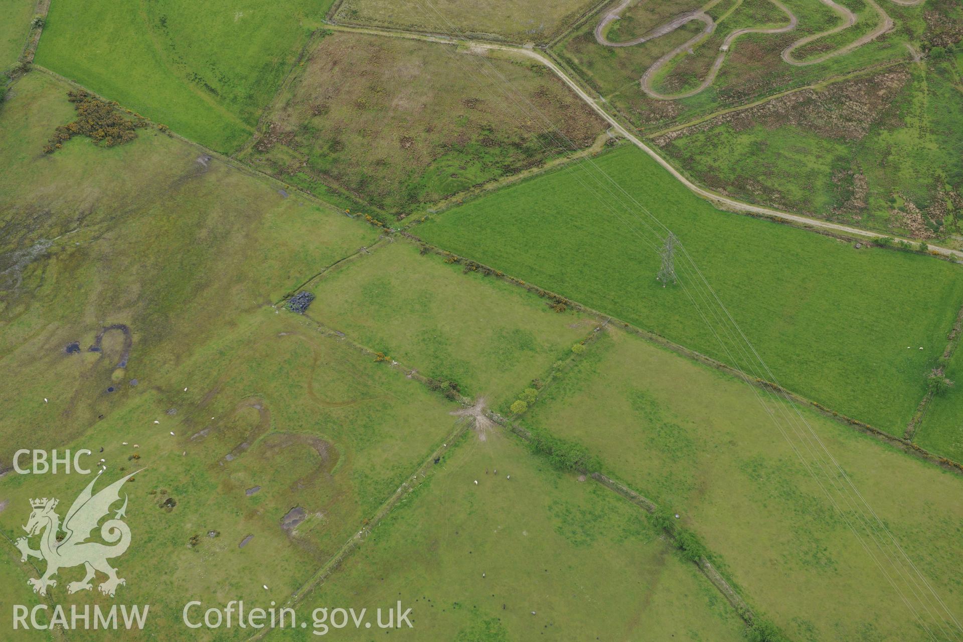 Cructarw round barrow, Llangeler. Oblique aerial photograph taken during the Royal Commission's programme of archaeological aerial reconnaissance by Toby Driver on 3rd June 2015.