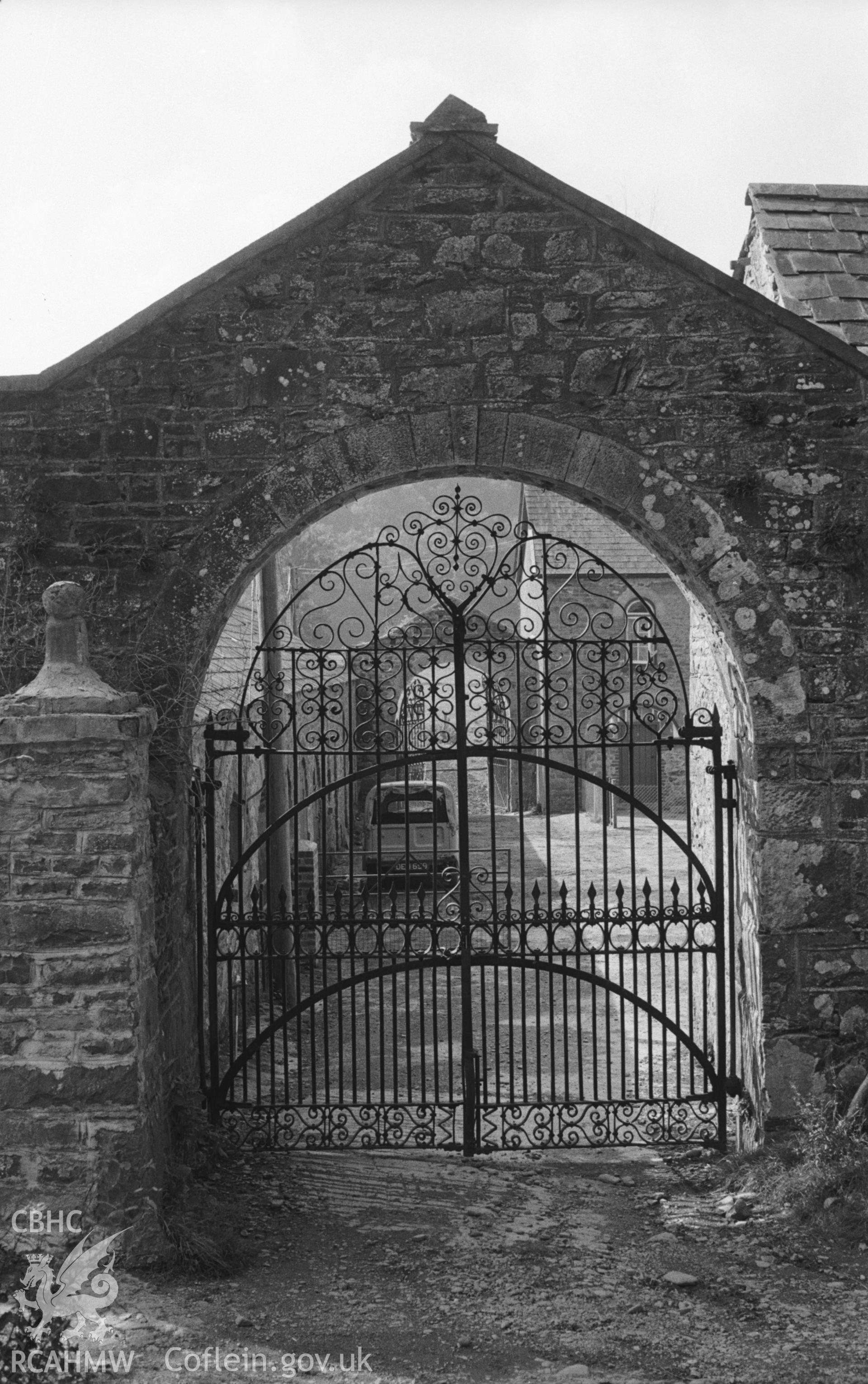 Digital copy of black & white negative showing ornate wrought iron gates at south east corner of Llanfair farmyard, Llandysul. South west gates (open) seen beyond. Photograph by Arthur O. Chater, August 1965, from SN 4334 4092, looking west north west.