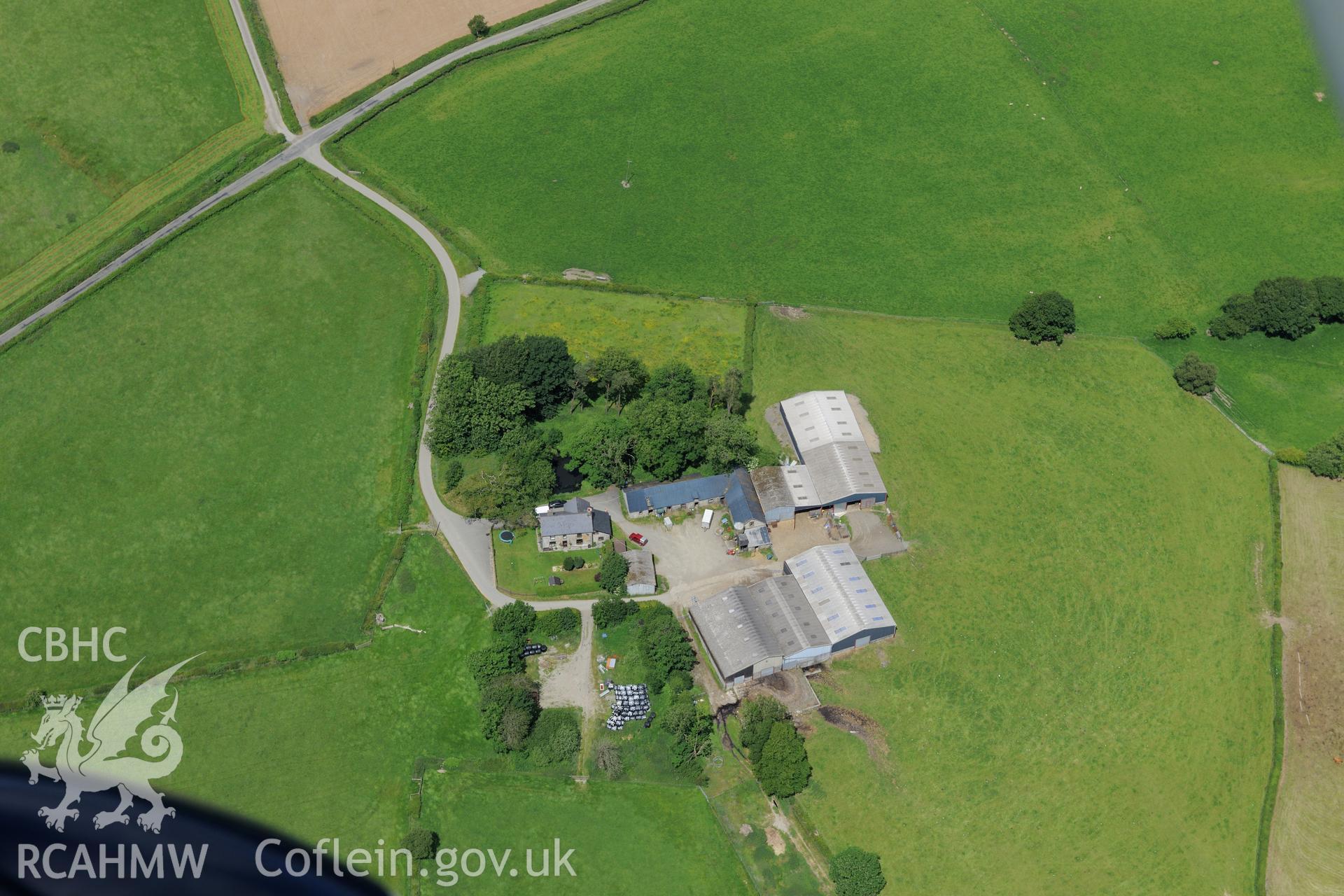 Caerau Roman military settlement, the Roman road between Beulah and Llandovery, the Roman road from Carmarthen to Castell Collen and Twdin motte, Caerau, west of Builth Wells. Oblique aerial photograph taken during the Royal Commission's programme of archaeological aerial reconnaissance by Toby Driver on 30th June 2015.