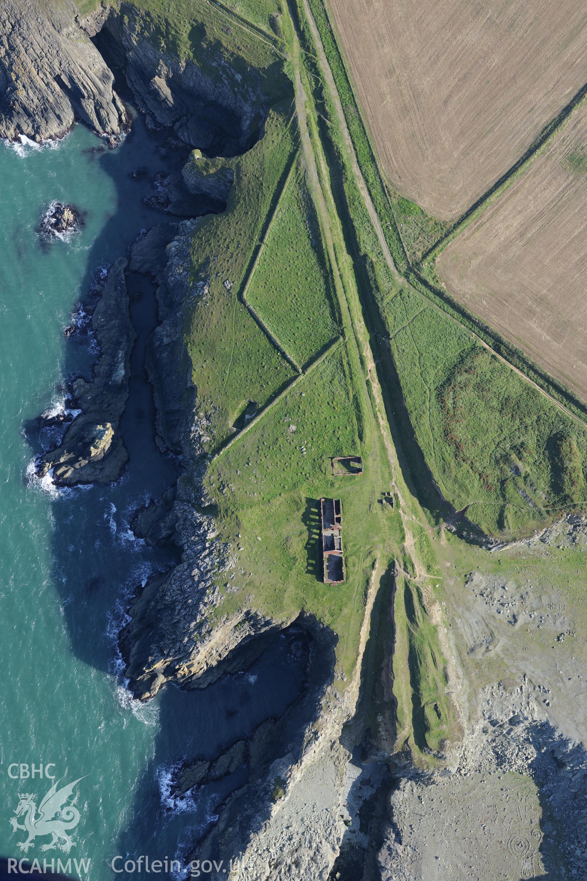 Remains of Porthgain stone quarry, including the offices and stores. Oblique aerial photograph taken during the Royal Commission's programme of archaeological aerial reconnaissance by Toby Driver on 30th September 2015.