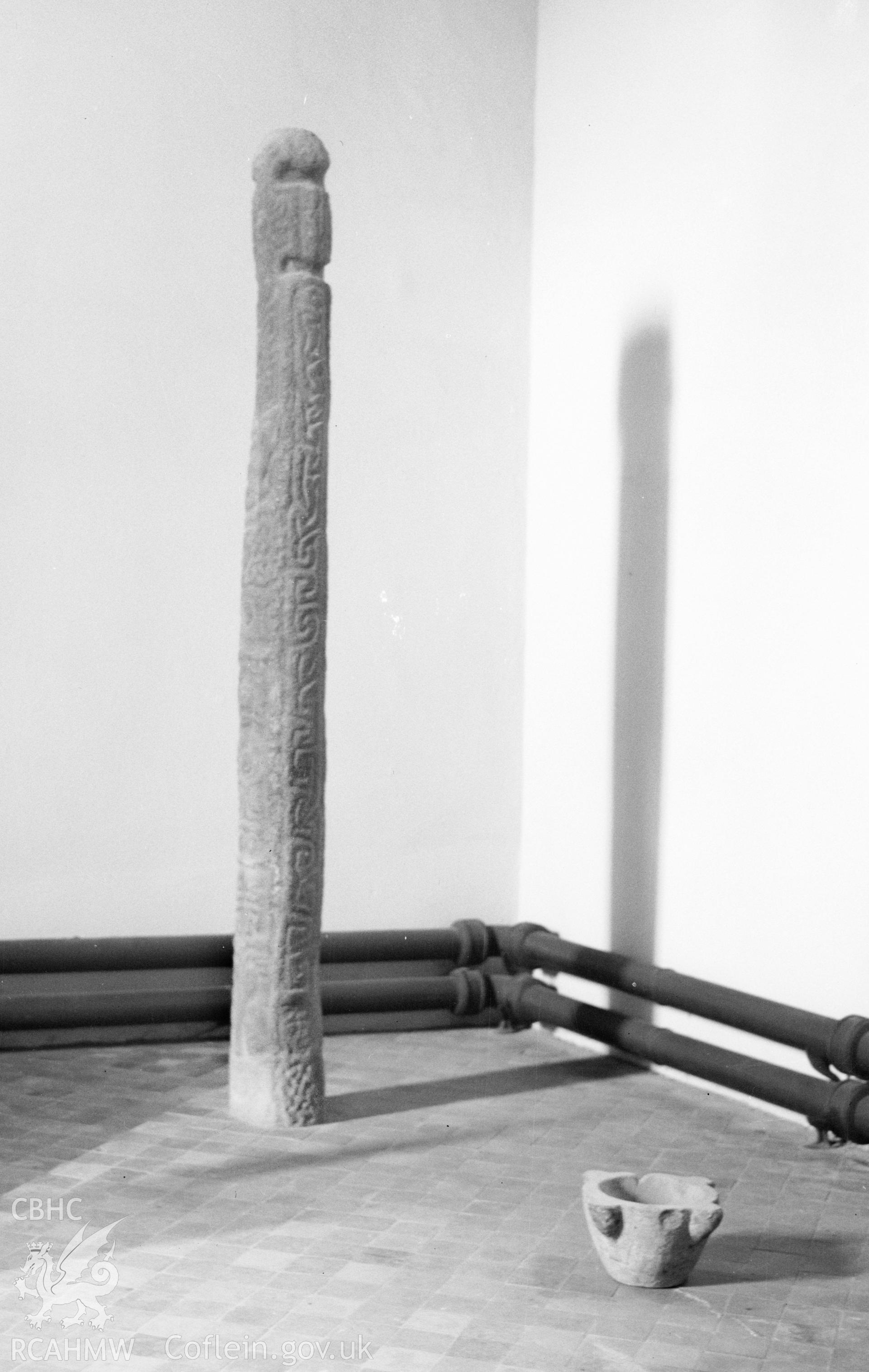 Digital copy of a nitrate negative showing view of early medieval inscribed cross shaft in the south trancept of St Padarn's Church, Llanbadarn Fawr, Ceredigion. From the National Building Record Postcard Collection.