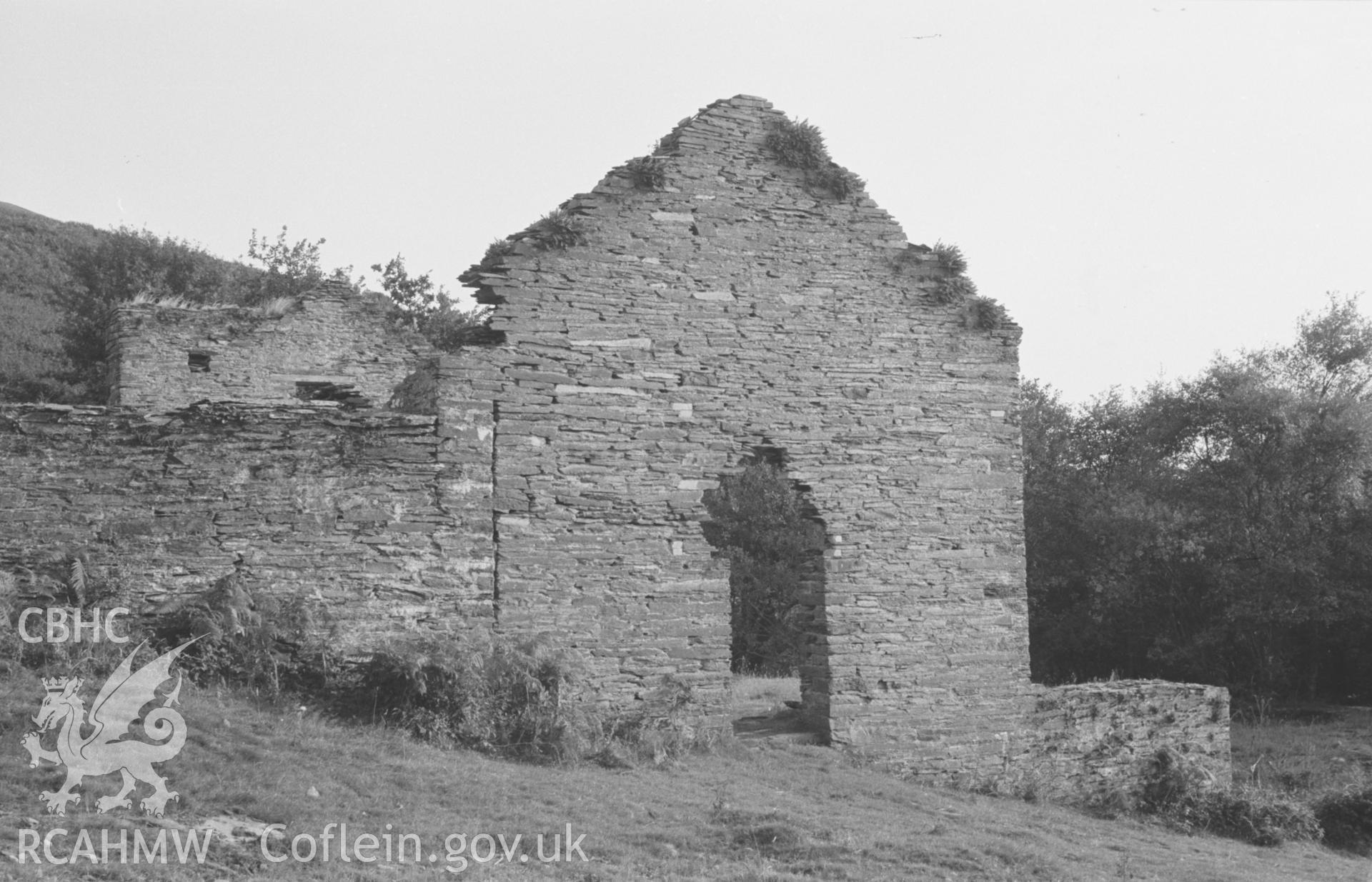 Digital copy of a black and white negative showing the ruins of the lower of the main mine buildings at Bryndyfi Mine. Dressing floors below on right. Photographed by Arthur O. Chater in August 1966 looking south south east from SN 683 934.