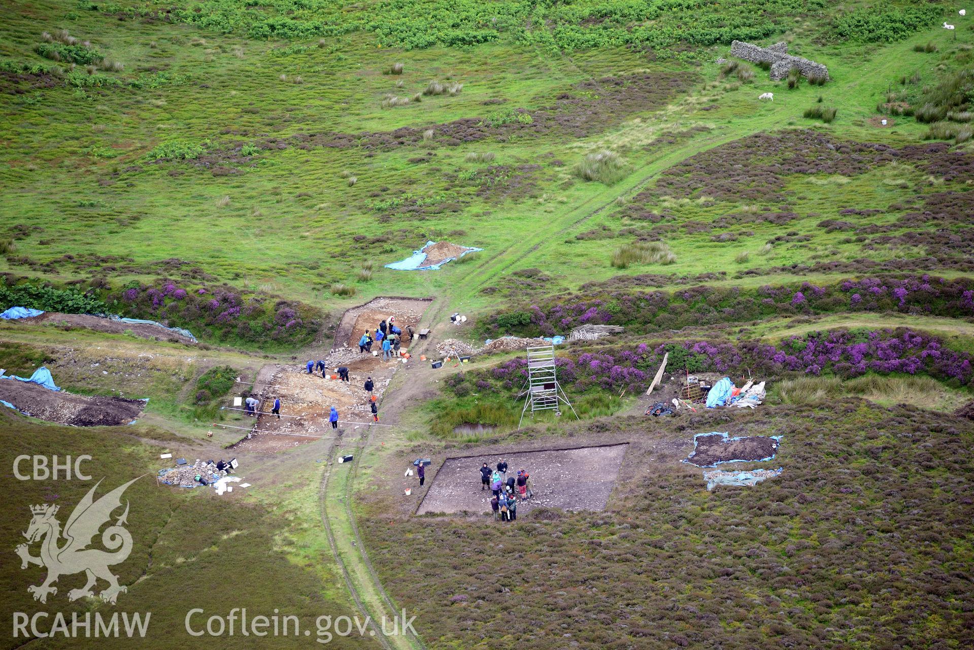 Penycloddiau Hilfort and Hut Platform V, Llangwyfan. Excavation by Liverpool University. Oblique aerial photograph taken during the Royal Commission's programme of archaeological aerial reconnaissance by Toby Driver on 30th July 2015.