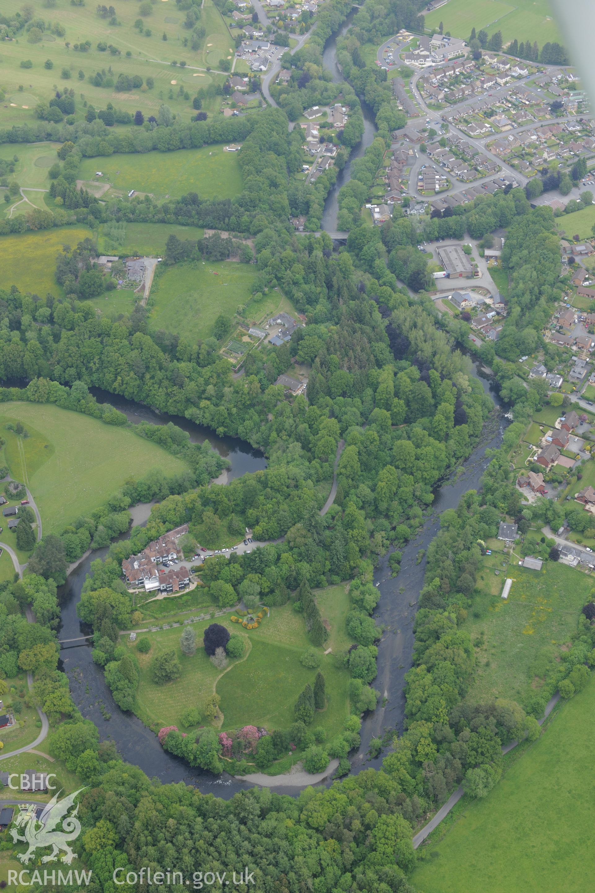 Caerberis mansion and garden, plus Caer Beris motte, and Builth Wells. Oblique aerial photograph taken during the Royal Commission's programme of archaeological aerial reconnaissance by Toby Driver on 11th June 2015.