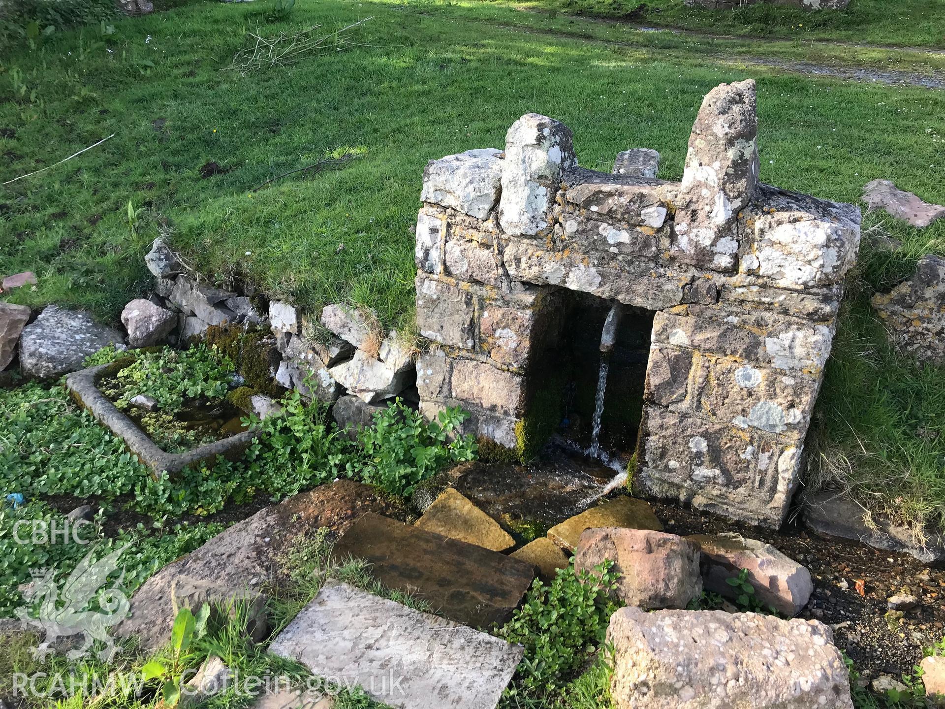 Colour photo showing view of well outside St. Cenydd's church, Llangenydd, taken by Paul R. Davis, 10th May 2018.