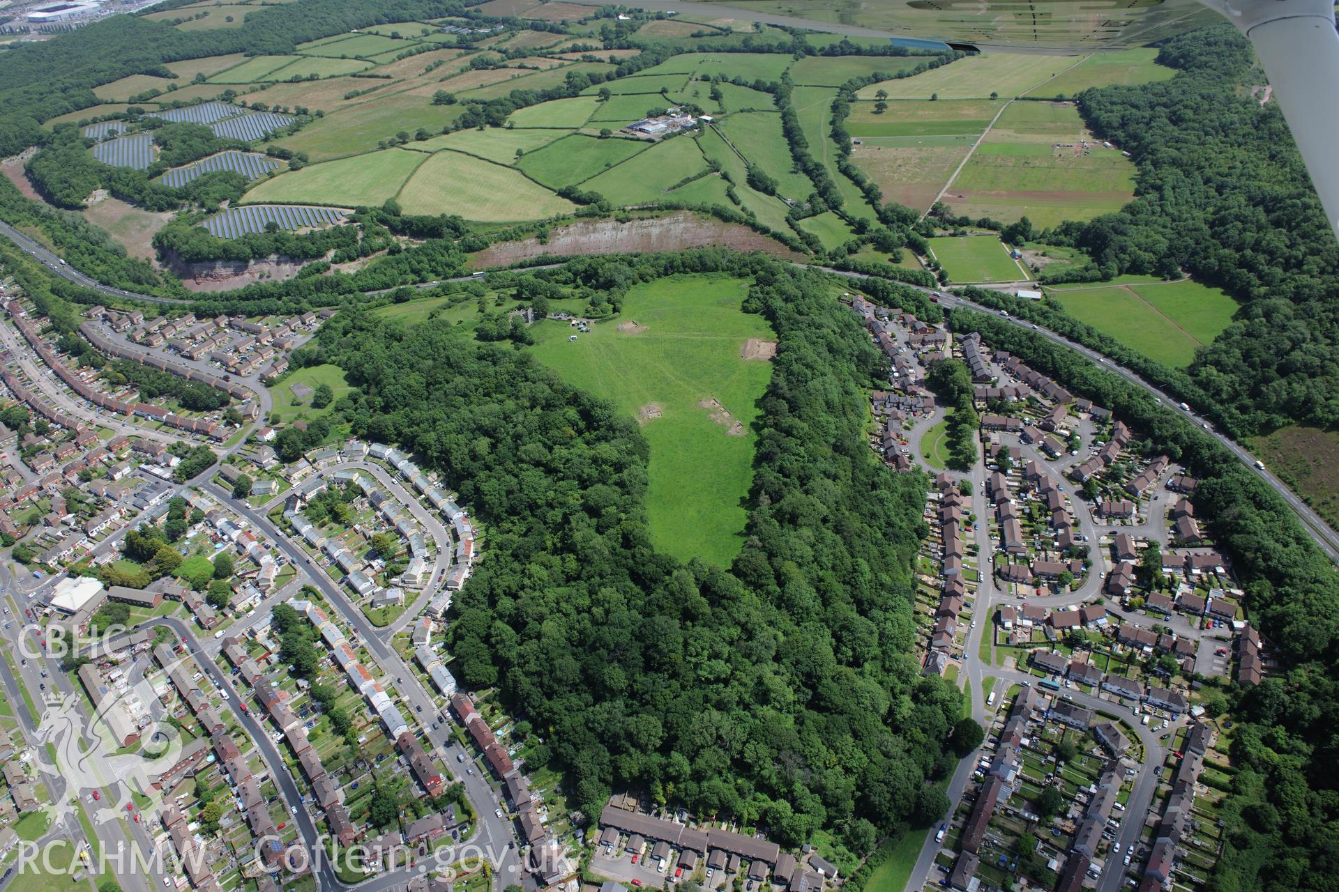 Caerau village and the excavation of Caerau Hillfort, Ely, conducted by Cardiff University. Oblique aerial photograph taken during the Royal Commission's programme of archaeological aerial reconnaissance by Toby Driver on 29th June 2015.