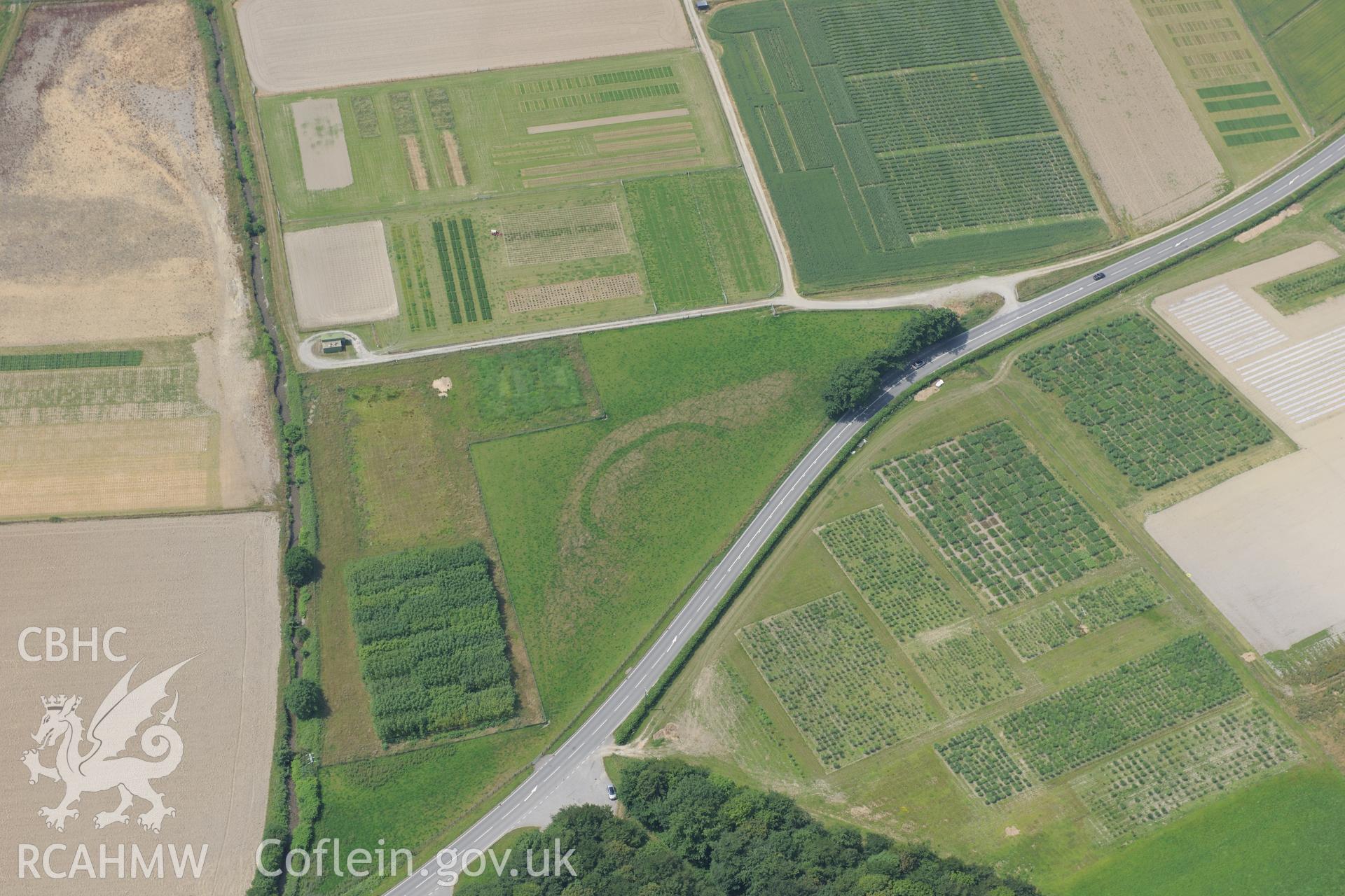 Gogerddan Enclosure, on the southern outskirts of Bow Street, Aberystwyth. Oblique aerial photograph taken during the Royal Commission?s programme of archaeological aerial reconnaissance by Toby Driver on 12th July 2013.