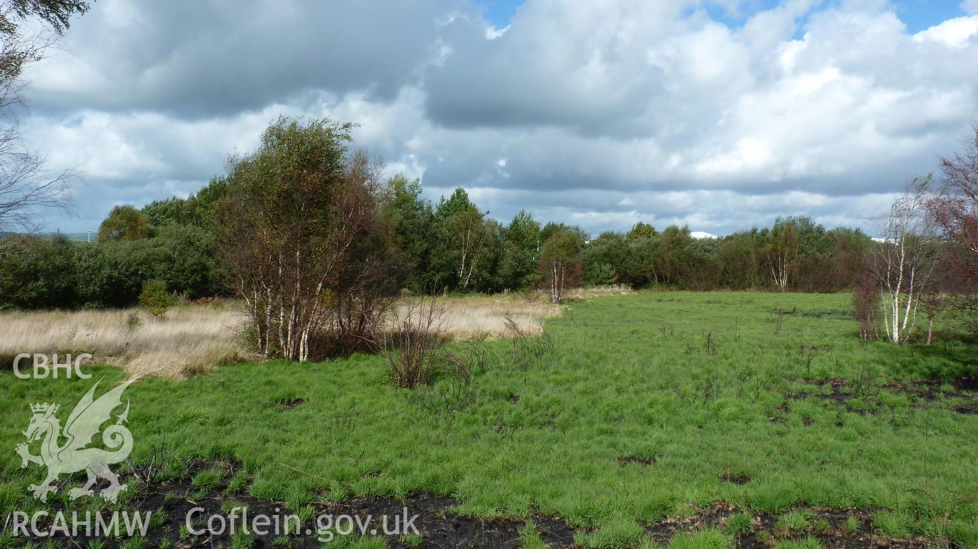 View from Carn Goch, looking north. Boundary of Garngoch Industrial Estate marked by tree line. Photographed during Setting Impact Assessment of Land off Phoenix Way, Garngoch Business Village, Swansea, by Archaeology Wales, 2018. Project number P2631.