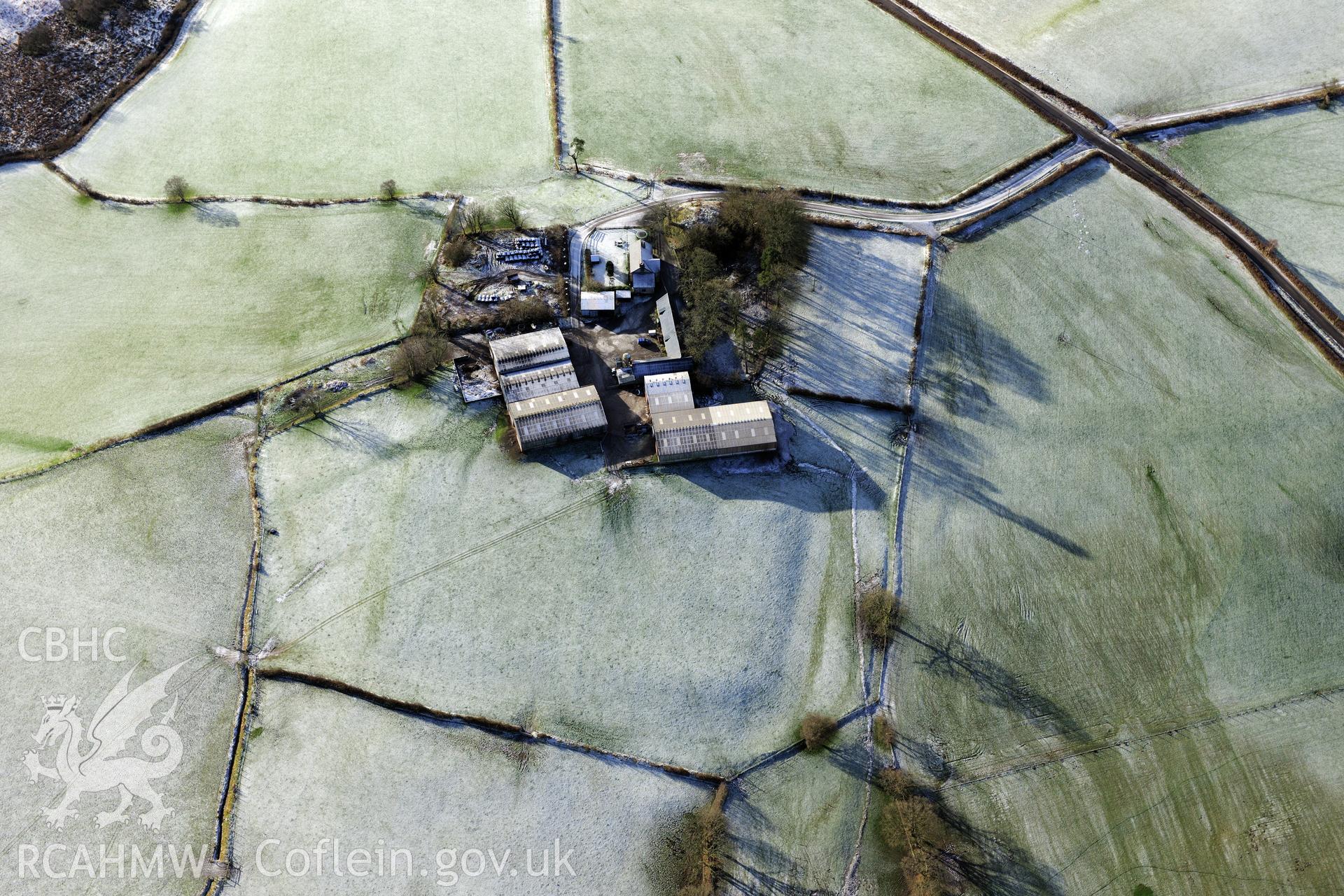 Twdin or Caerau Motte, Caerau Roman fort and military settlement, and the Roman road from Carmarthen to Castell Collen (RR623). Oblique aerial photograph taken during the RCAHMW?s programme of archaeological aerial reconnaissance by Toby Driver 15/01/2013.