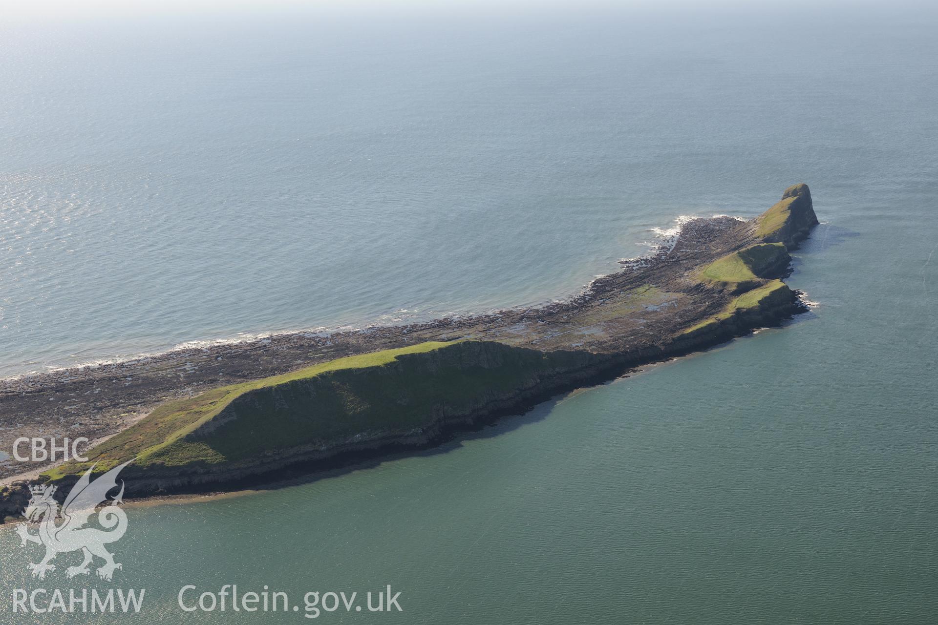 Worm's Head and the enclosure on its north eastern side, near Rhossili, on the western coast of the Gower Peninsula. Oblique aerial photograph taken during the Royal Commission's programme of archaeological aerial reconnaissance by Toby Driver on 30th September 2015.