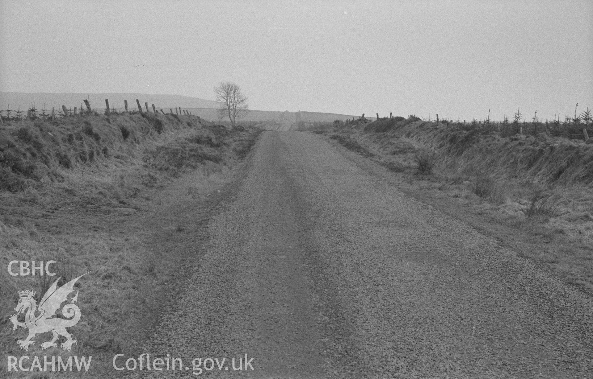 Digital copy of a black and white negative showing view up Sarn Helen Roman road near Llanfair Clydogau, where it reaches 1050ft. Photographed in April 1963 by Arthur O. Chater from Grid Reference SN 636 495, looking south south east.