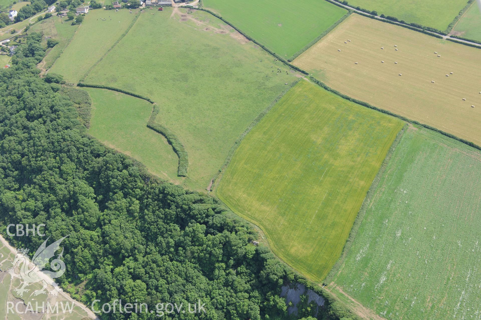 Bovehill Farm defended enclosure and Tor-Gro suggested enclosure, east of Cheriton, on the Gower Peninsula. Oblique aerial photograph taken during the Royal Commission?s programme of archaeological aerial reconnaissance by Toby Driver on 16th July 2013.