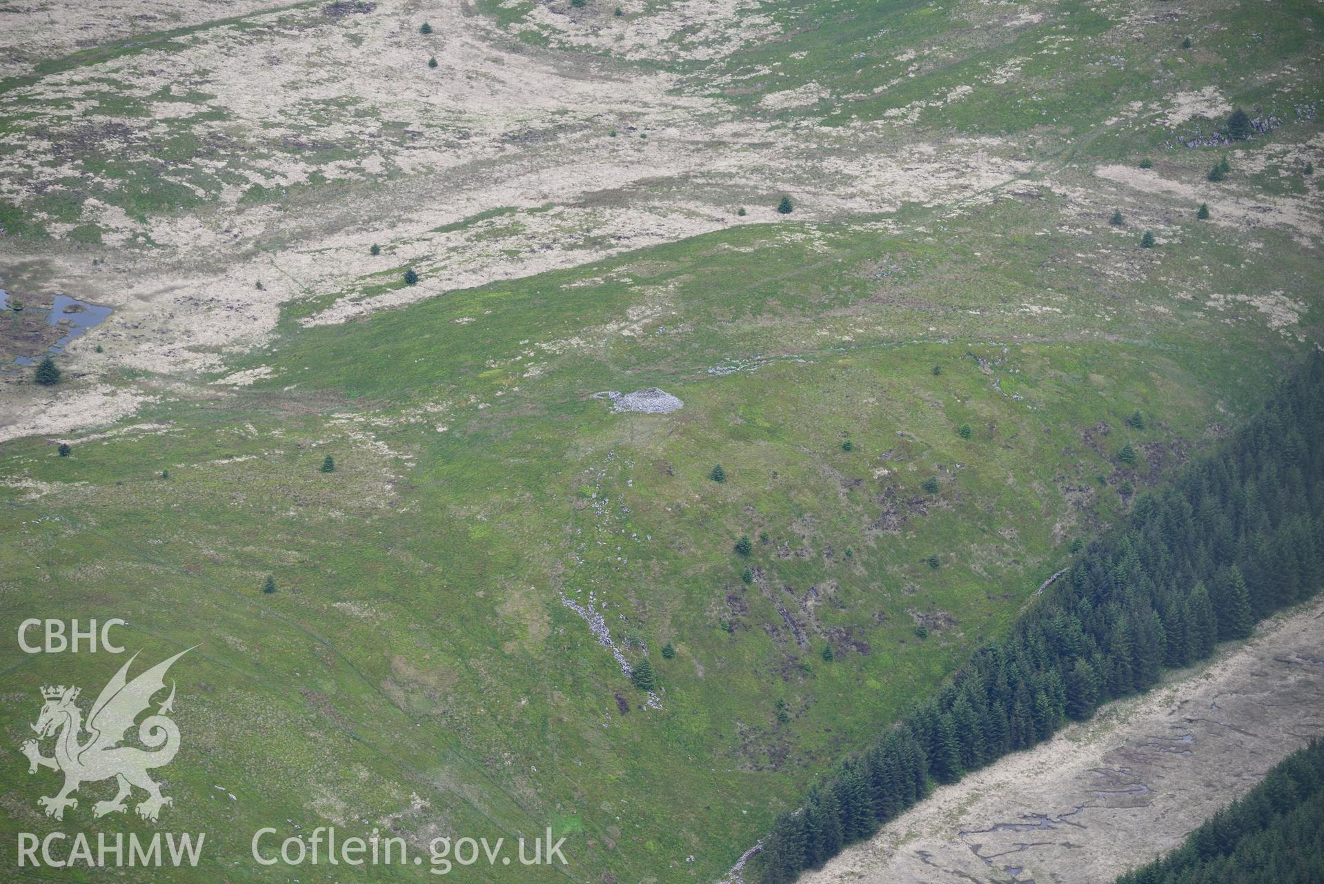 Carn Fawr cairn, fold and shelter. Oblique aerial photograph taken during the Royal Commission's programme of archaeological aerial reconnaissance by Toby Driver on 3rd June 2015.