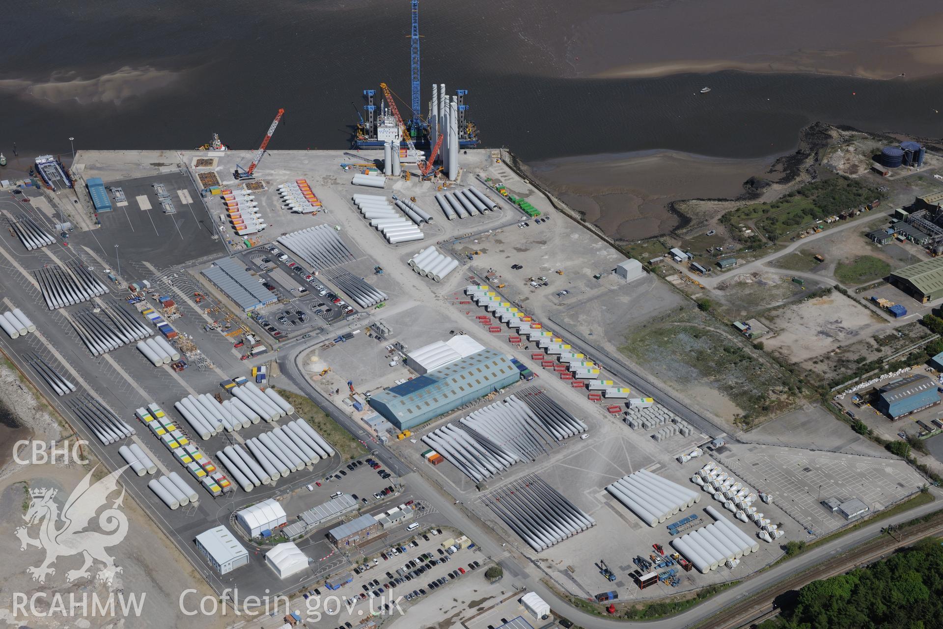 Mostyn Quay in the port of Mostyn, with windfarm parts. Oblique aerial photograph taken during the Royal Commission?s programme of archaeological aerial reconnaissance by Toby Driver on 22nd May 2013.