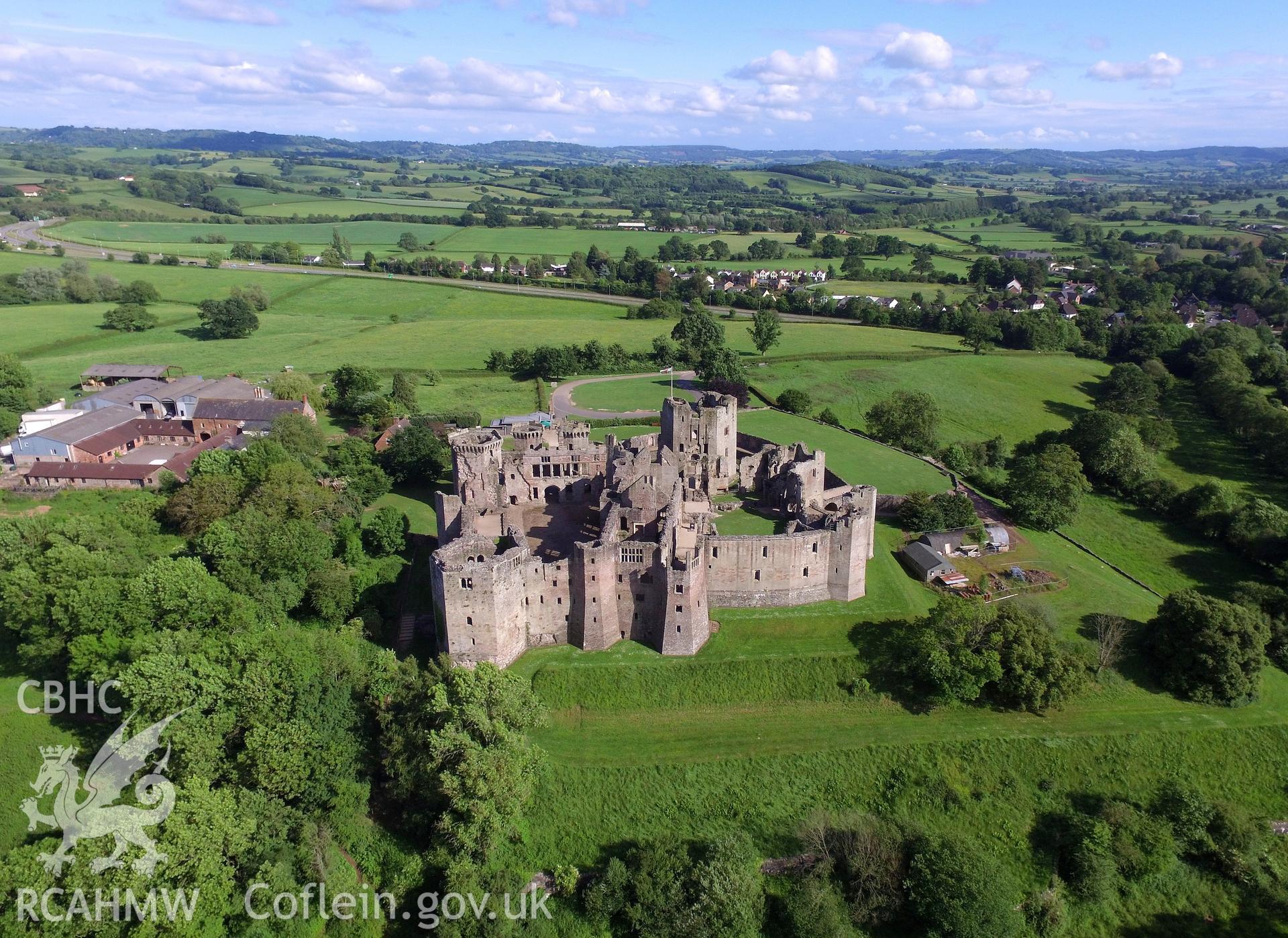 Aerial view from the north of Raglan Castle and Castle Farm, Raglan. Colour photograph taken by Paul R. Davis on 3rd June 2017.