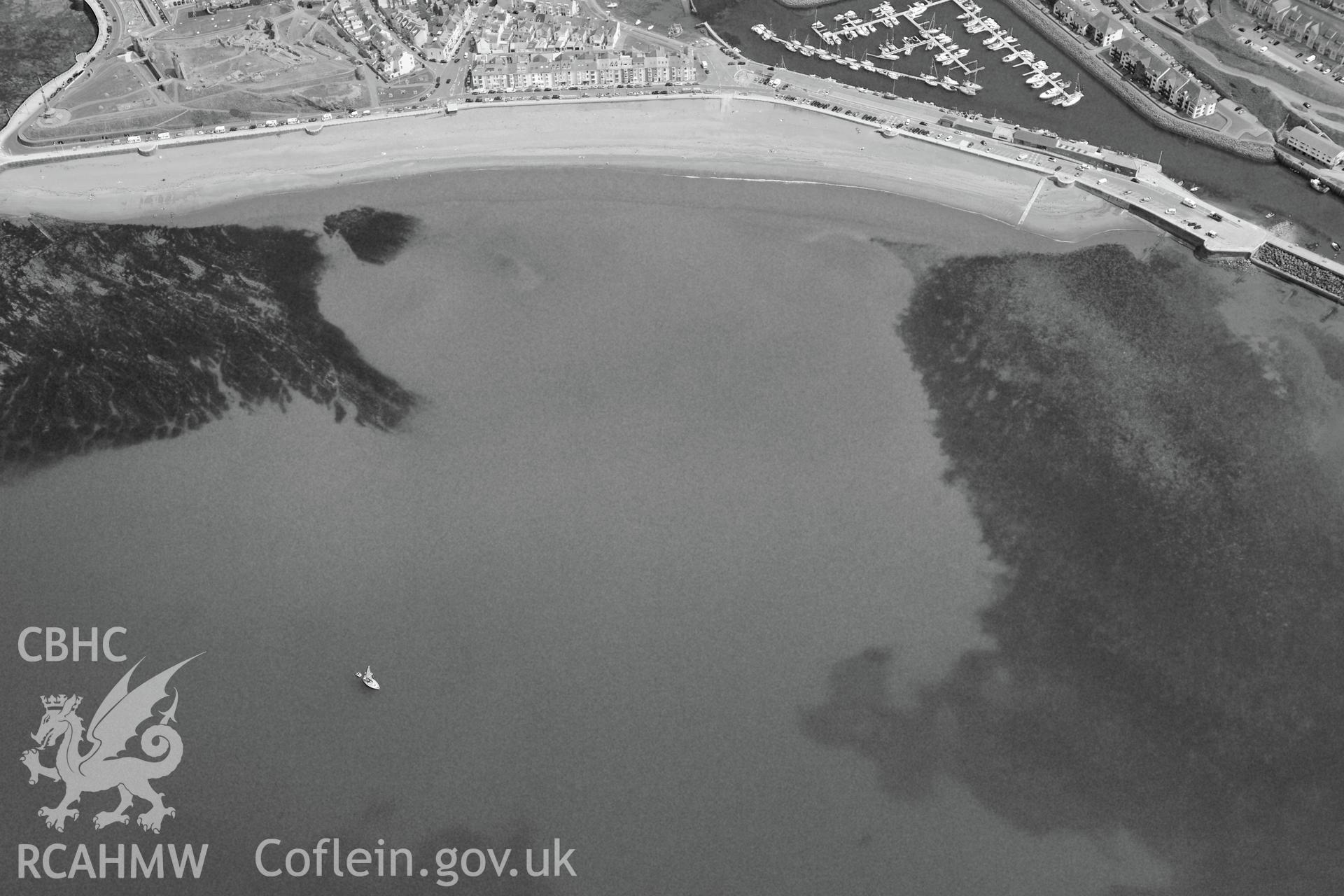 The town of Aberystwyth, including views of the castle, harbour and south beach. Oblique aerial photograph taken during the Royal Commission?s programme of archaeological aerial reconnaissance by Toby Driver on 12 July 2013.