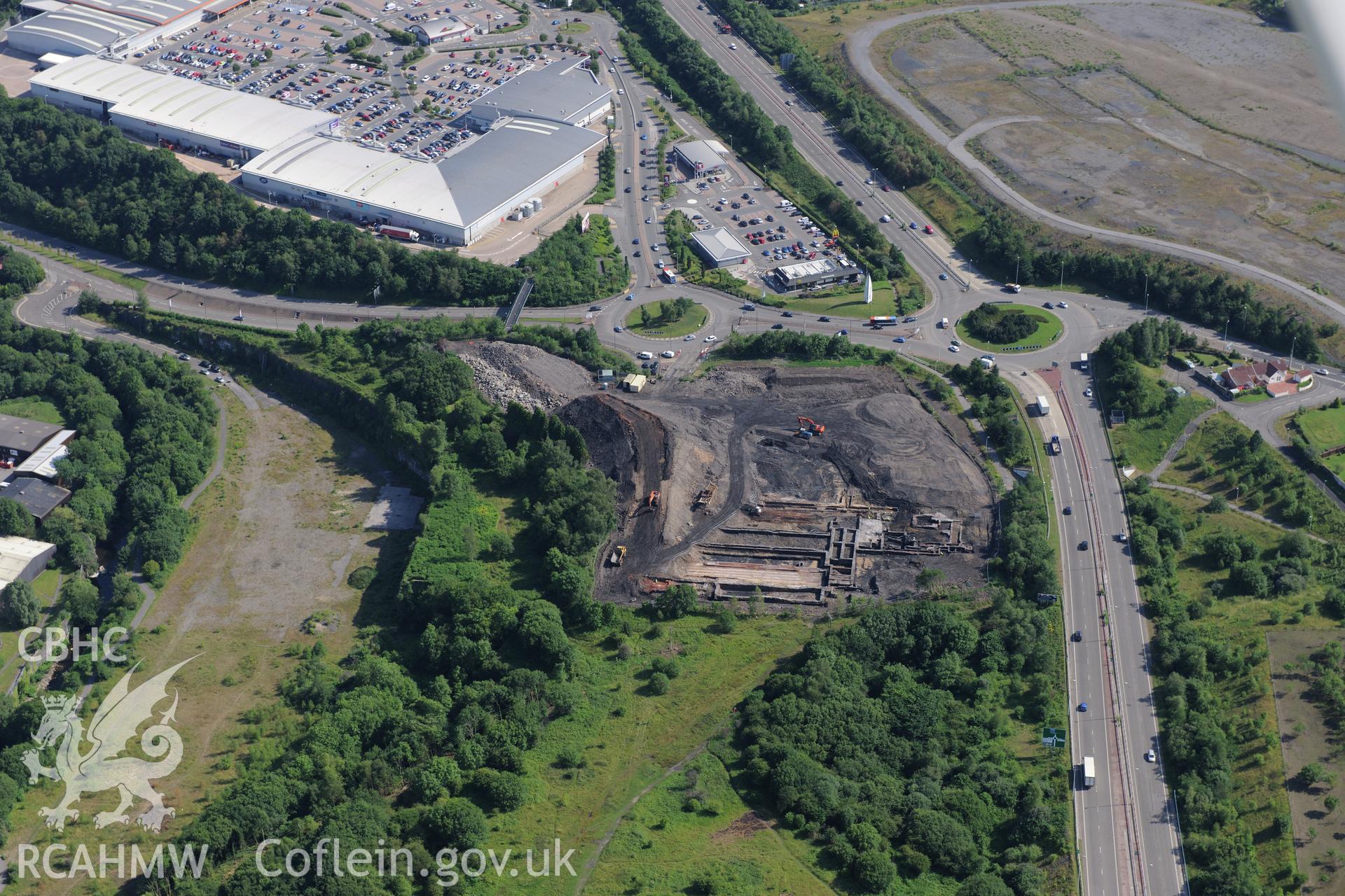 Site of former Rotax factory, Cyfarthfa Retail Park, and Cyfarthfa Ironworks including the remains of its blast furnaces, under excavation by Glamorgan-Gwent Archaeological Trust. Oblique aerial photograph taken during the Royal Commission?s programme of