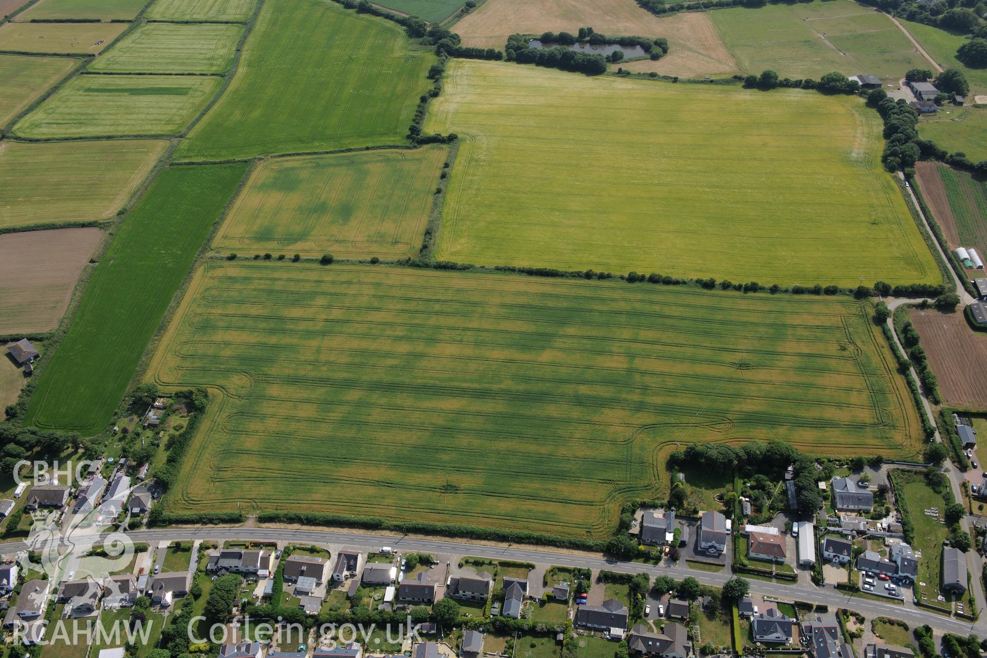 Hearson Farm defended enclosures, Hill Mountain, north east of Milford Haven. Oblique aerial photograph taken during the Royal Commission?s programme of archaeological aerial reconnaissance by Toby Driver on 16th July 2013.