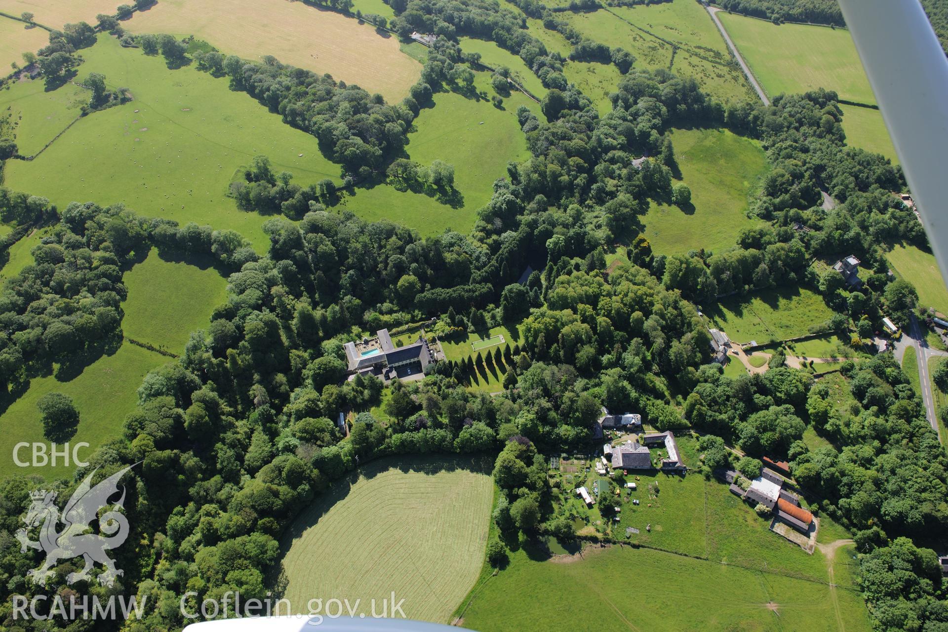 Plas Boduan surrounded by its park and gardens. Oblique aerial photograph taken during the Royal Commission's programme of archaeological aerial reconnaissance by Toby Driver on 23rd June 2015.