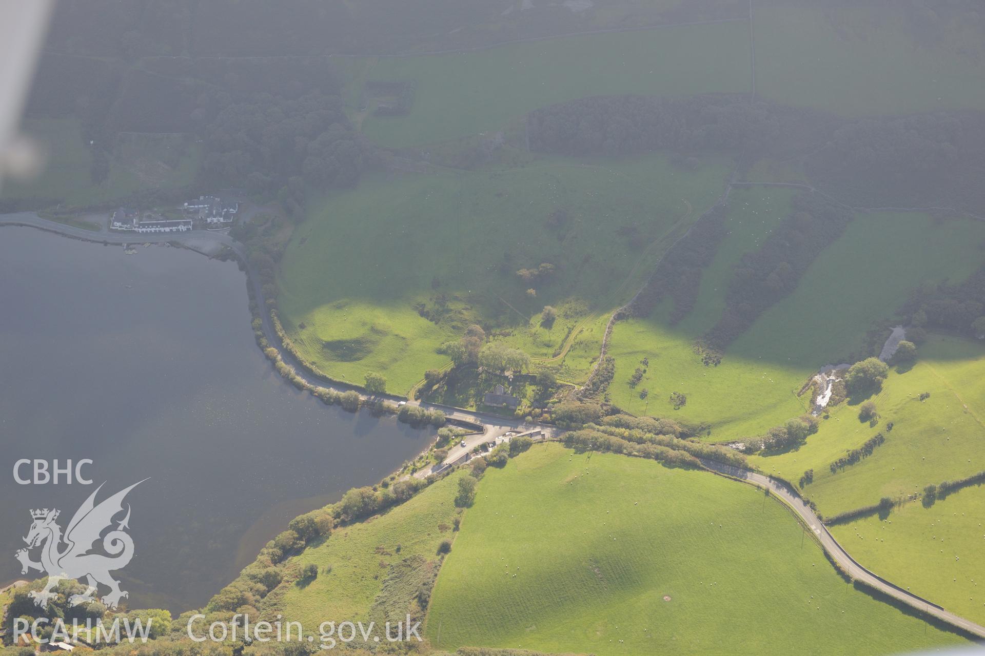 St. Mary's church, Ty'n-y-Cornel Hotel & Tal-y-Llyn enclosure or Roman fortlet, on shore of Tal-y-Llyn lake, Corris. Oblique aerial photograph taken during Royal Commission's programme of archaeological aerial reconnaissance by Toby Driver on 2/10/2015.