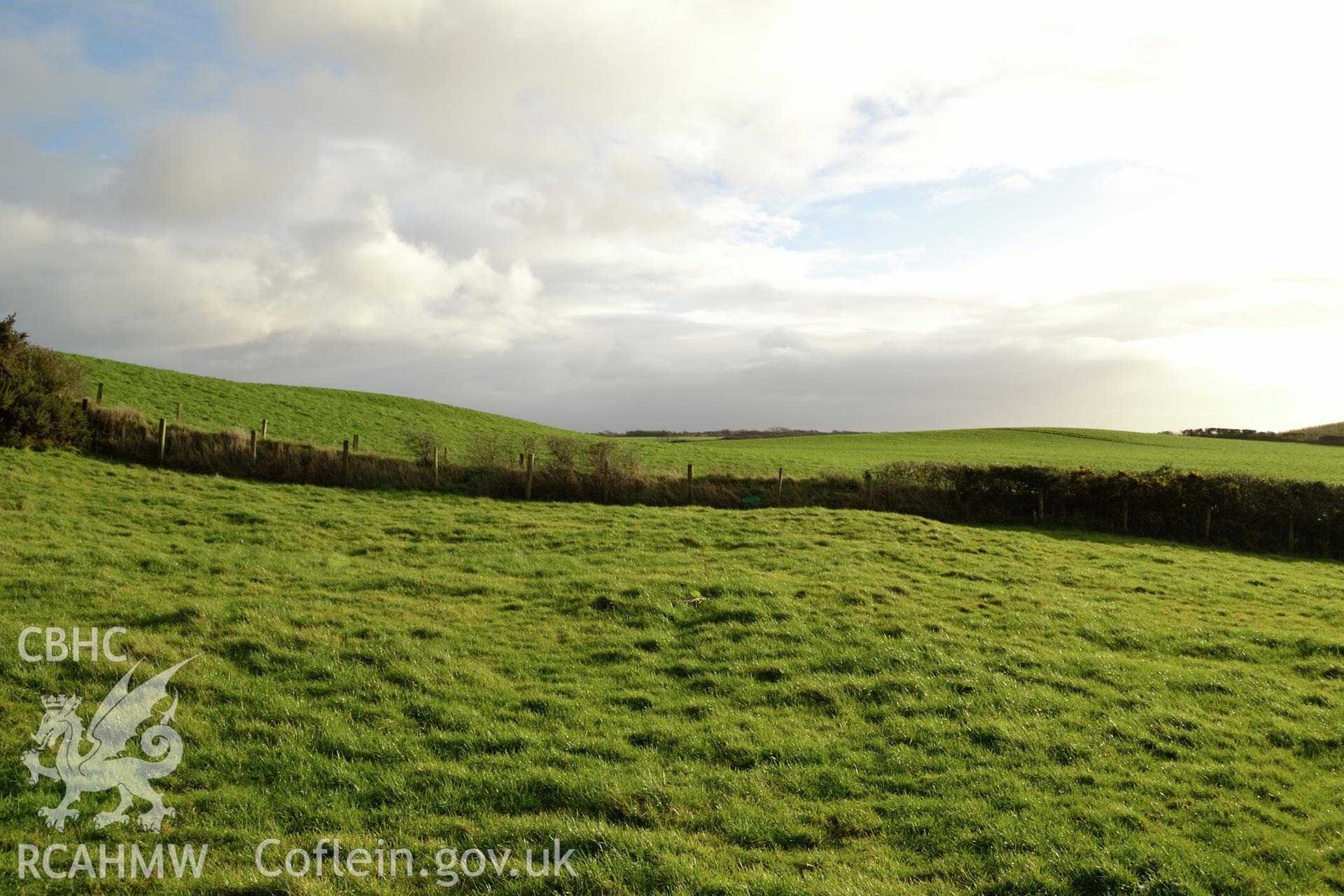 View towards new development from lower (southern) part of Tomen Fawr. Photographed by Gwynedd Archaeological Trust during impact assessment of the site on 20th December 2018. Project no. G2564.