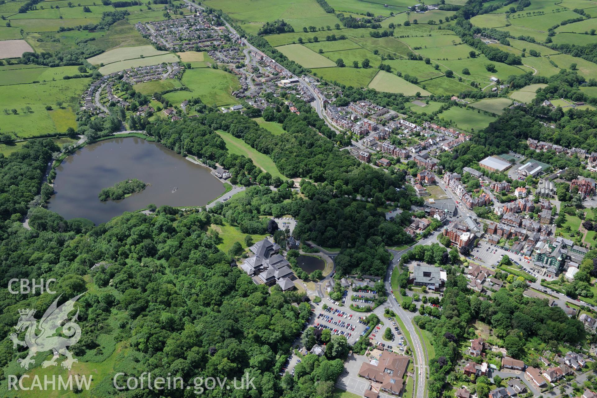 Powys County Hall and the Lake Cottage, Llandrindod Wells. Oblique aerial photograph taken during the Royal Commission's programme of archaeological aerial reconnaissance by Toby Driver on 30th June 2015.