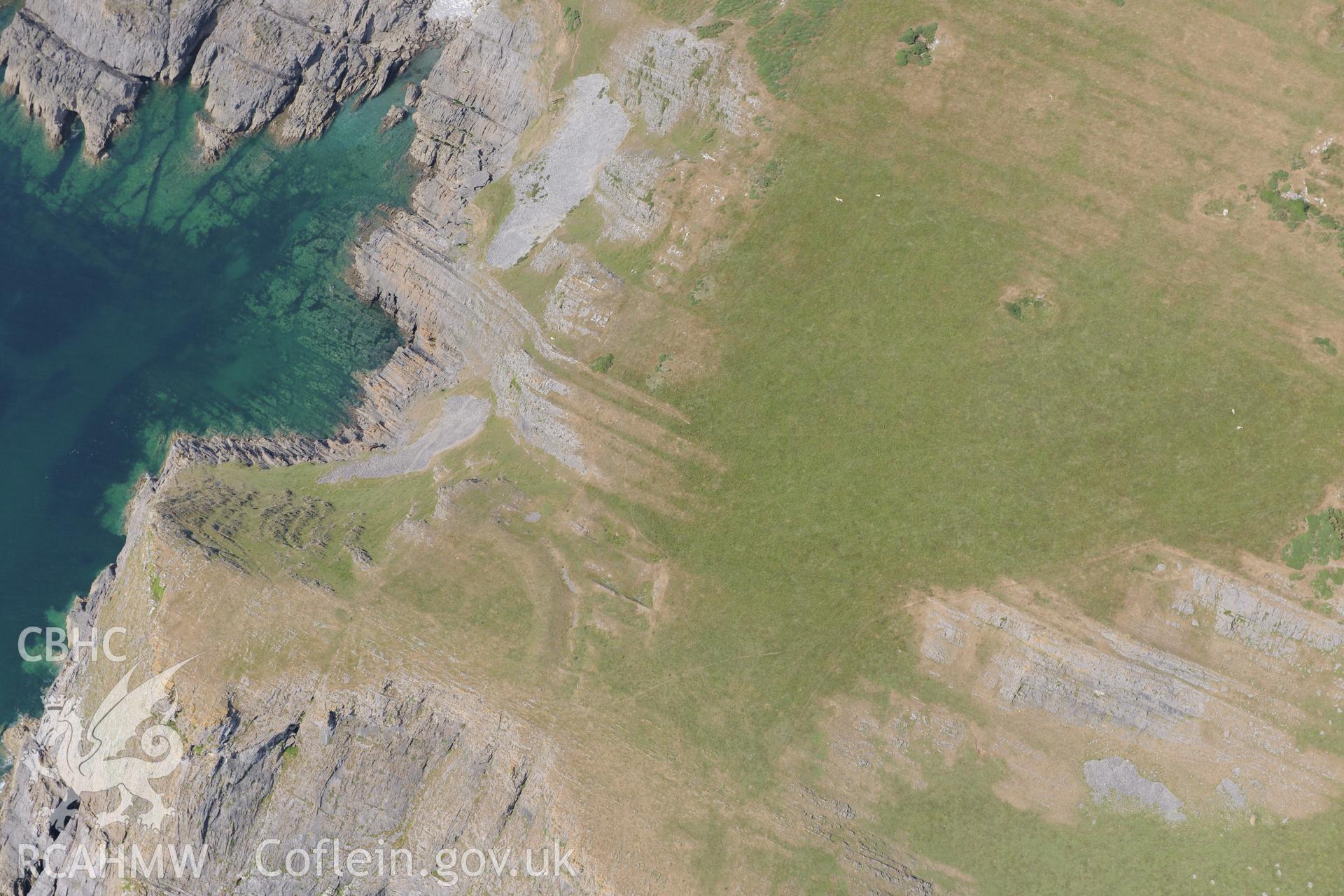 Horse Cliff Promontory Fort, on the south western coast of the Gower. Oblique aerial photograph taken during the Royal Commission?s programme of archaeological aerial reconnaissance by Toby Driver on 16th July 2013.