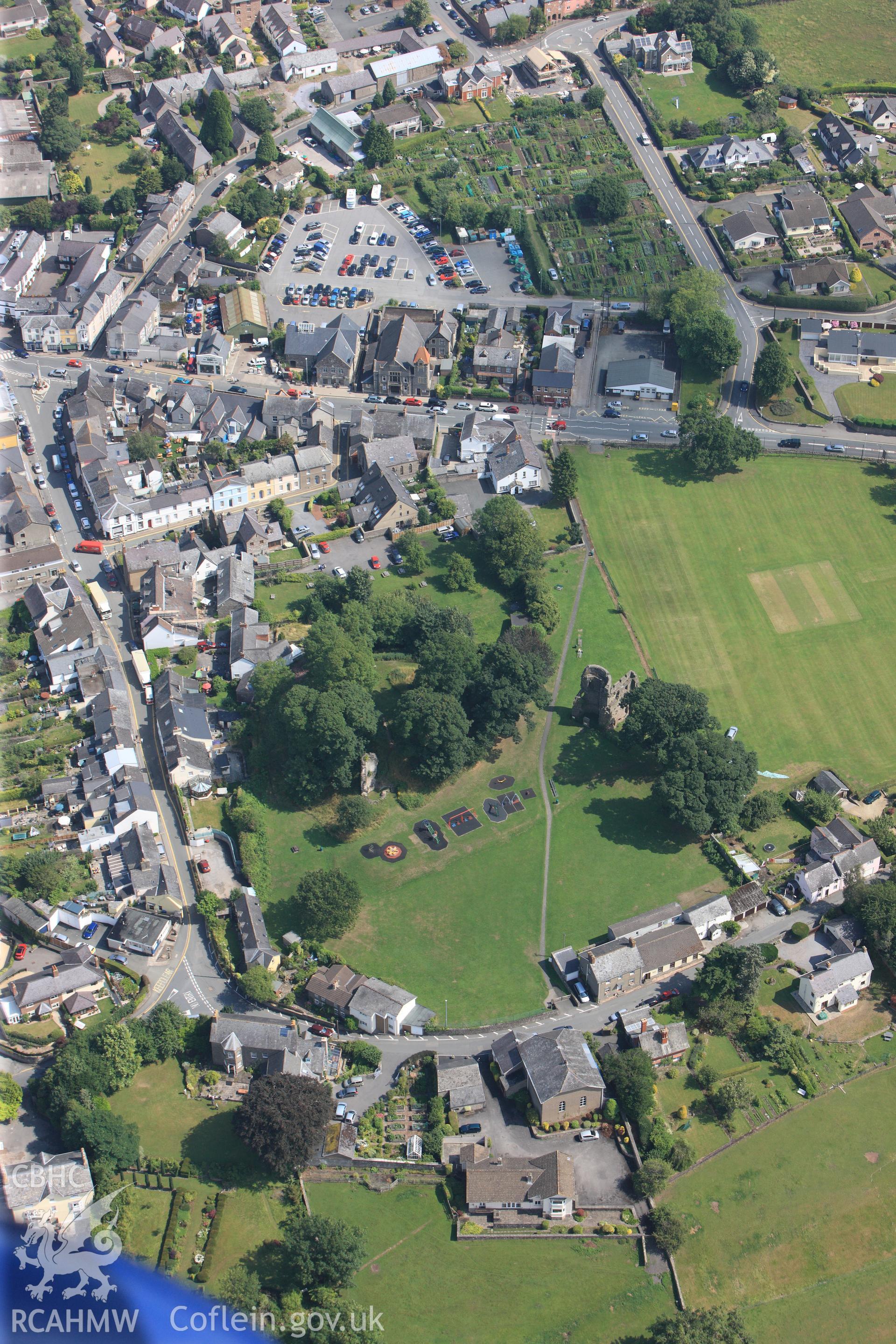 The remains of Alisby's Castle, on the southern edge of Crickhowell. Oblique aerial photograph taken during the Royal Commission?s programme of archaeological aerial reconnaissance by Toby Driver on 1st August 2013.