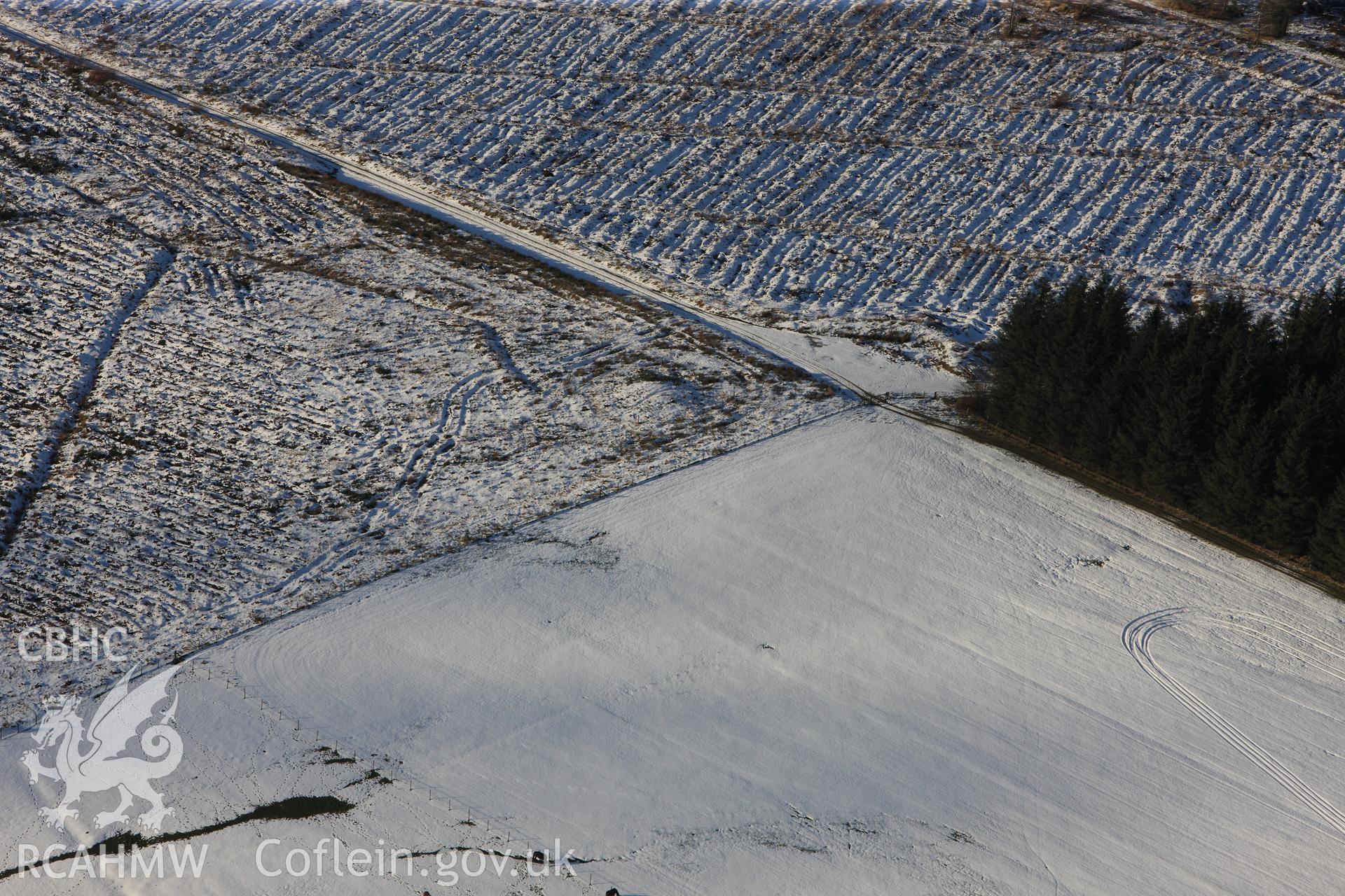 RCAHMW colour oblique photograph of Block Wood Barrow, under snow. Taken by Toby Driver on 18/12/2011.