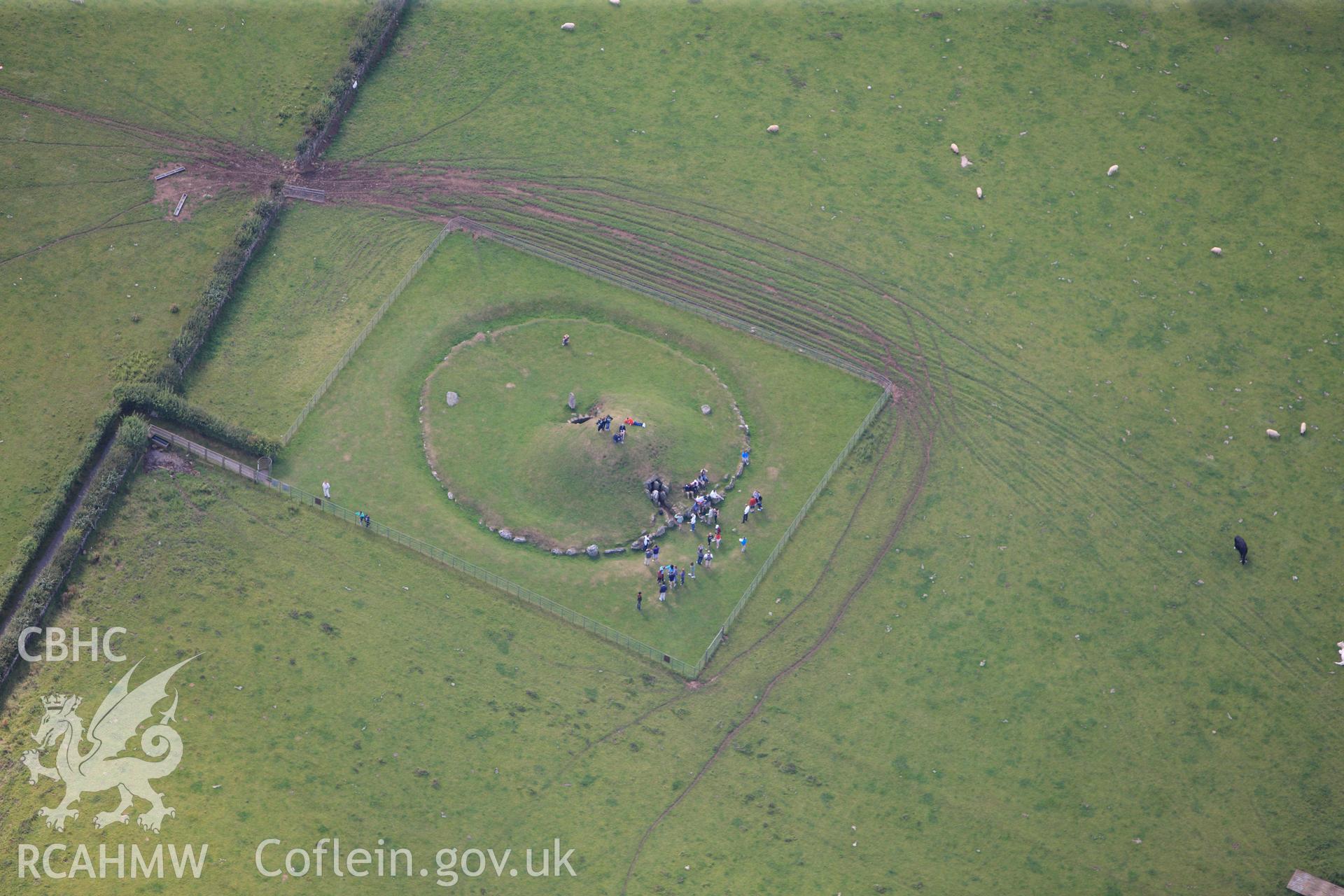 RCAHMW colour oblique photograph of Bryn Celli Ddu, chambered tomb, with public tour. Taken by Toby Driver on 20/07/2011.