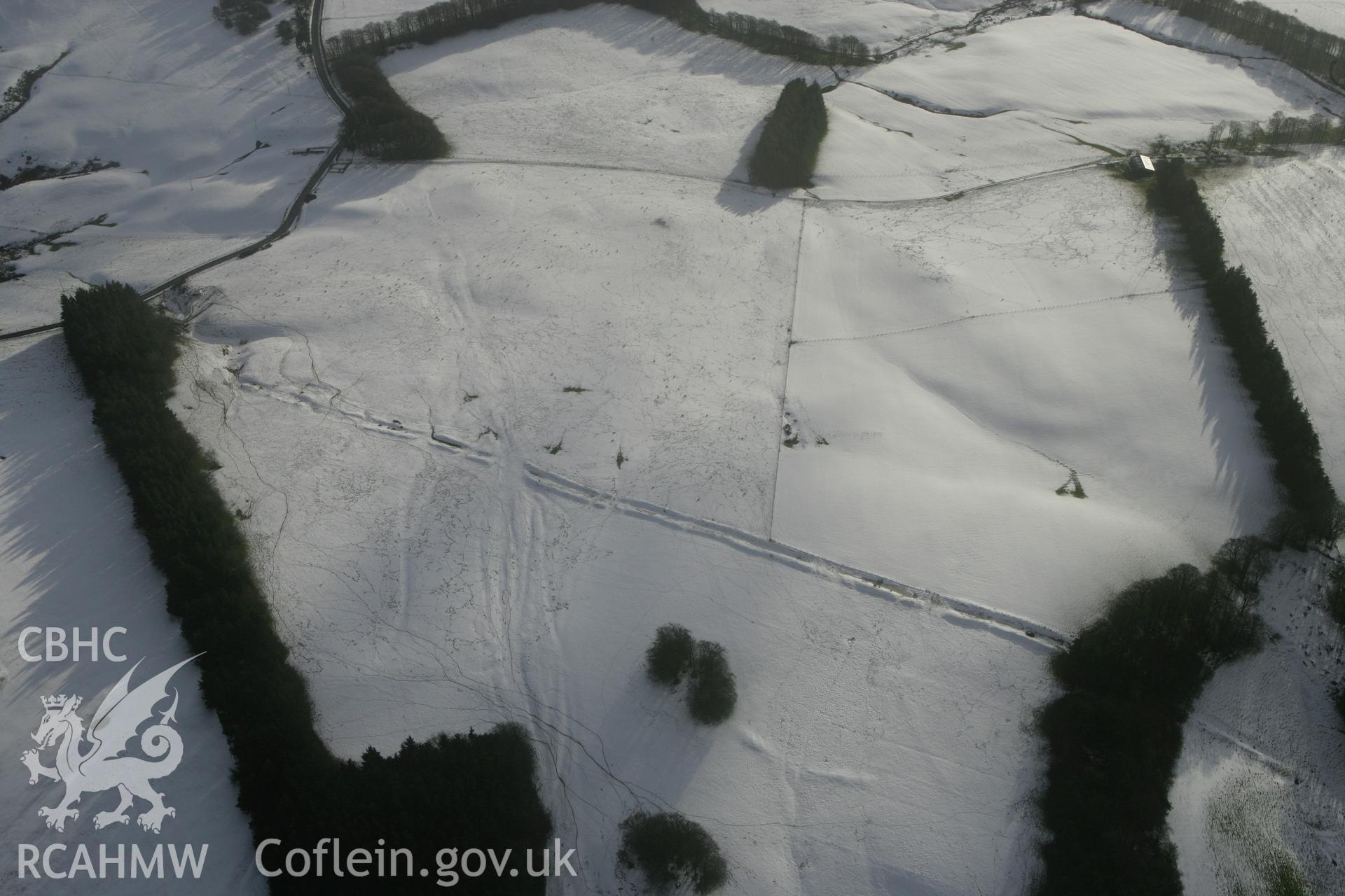 RCAHMW colour oblique photograph of Crugyn Bank, under snow, with round barrows. Taken by Toby Driver on 18/12/2011.