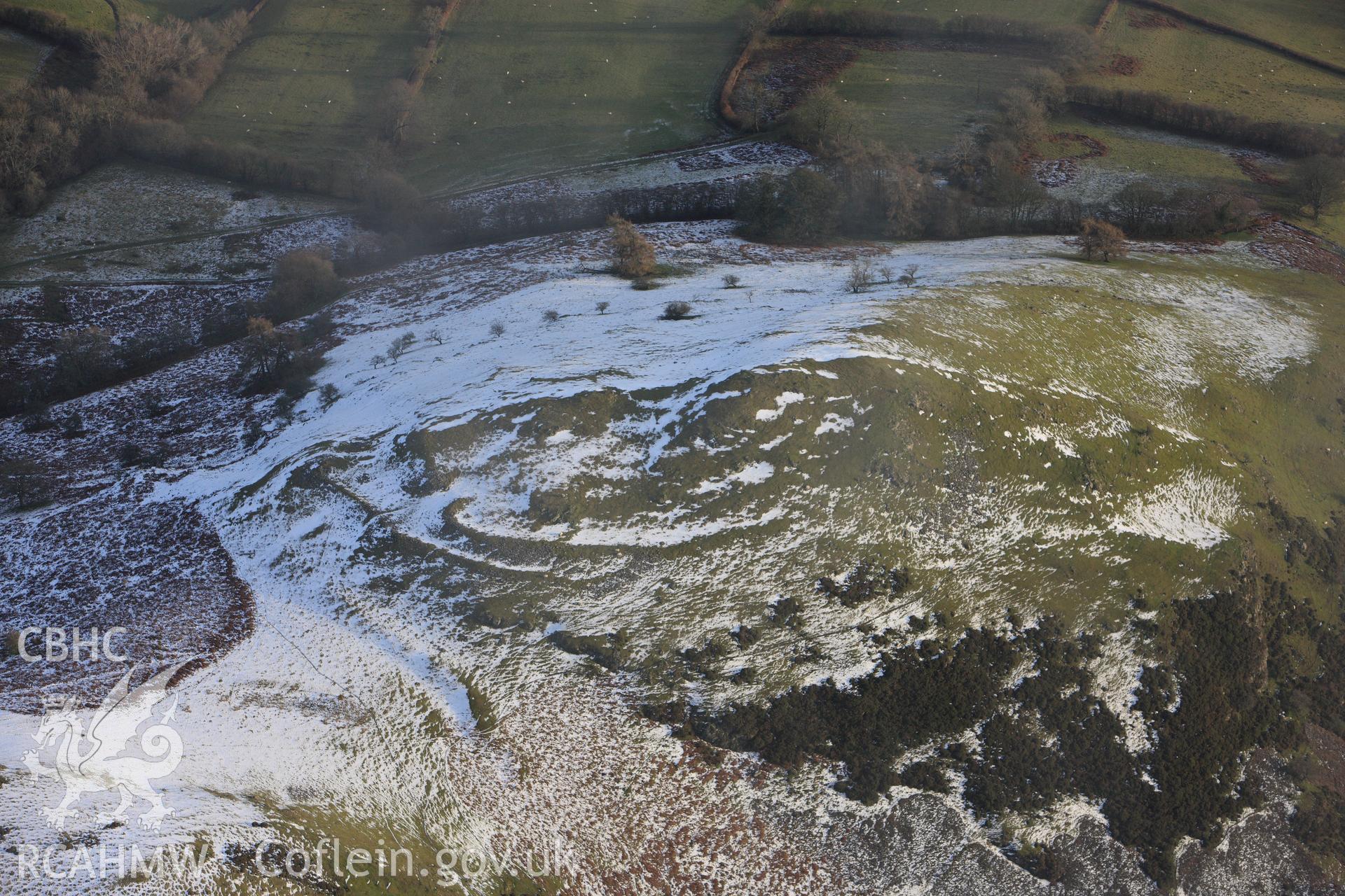 RCAHMW colour oblique photograph of Caer Einion hillfort, with melting snow. Taken by Toby Driver on 18/12/2011.