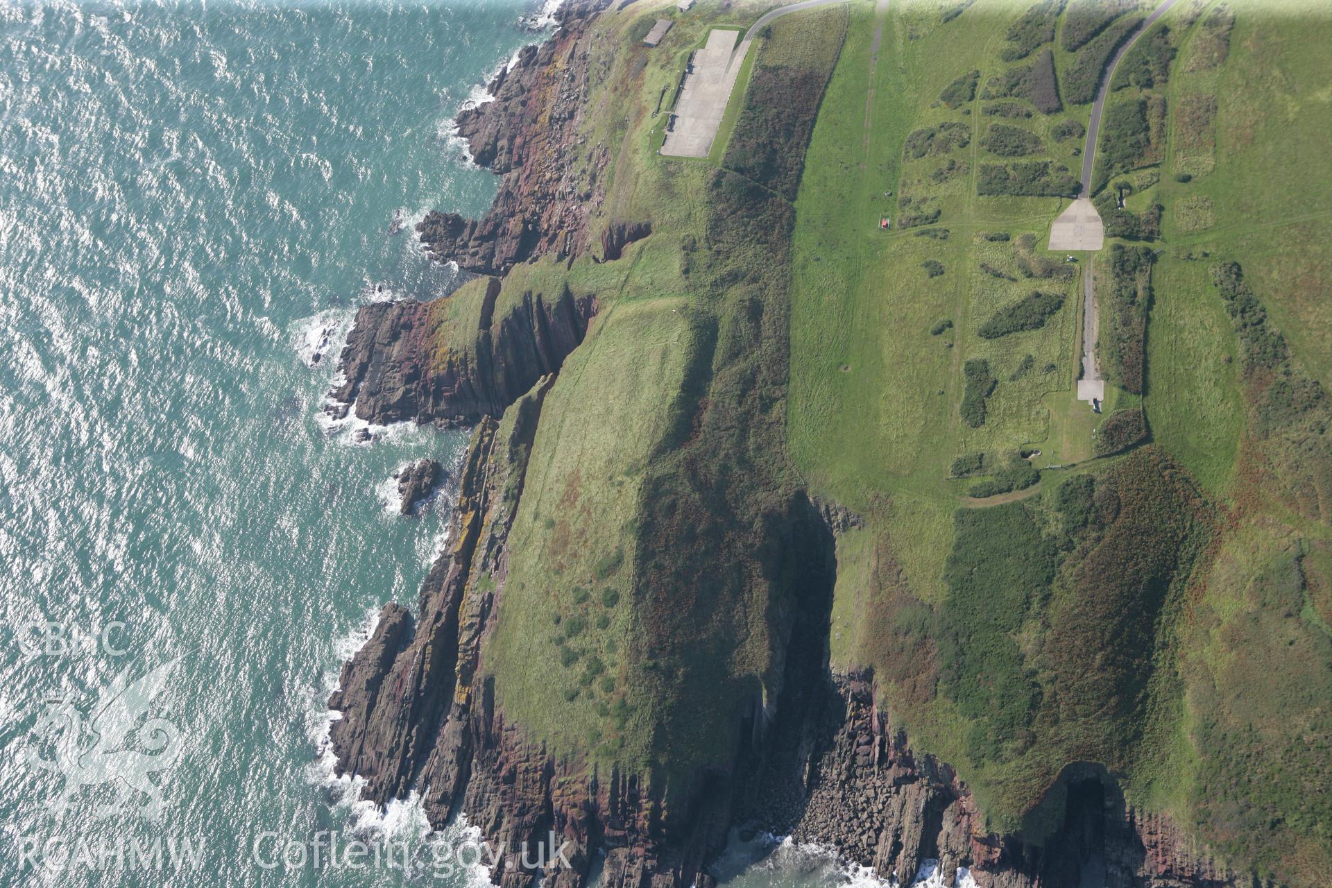 RCAHMW colour oblique photograph of Old Castle Head promontary fort, looking towards Manorbier radar station. Taken by Toby Driver and Oliver Davies on 28/09/2011.