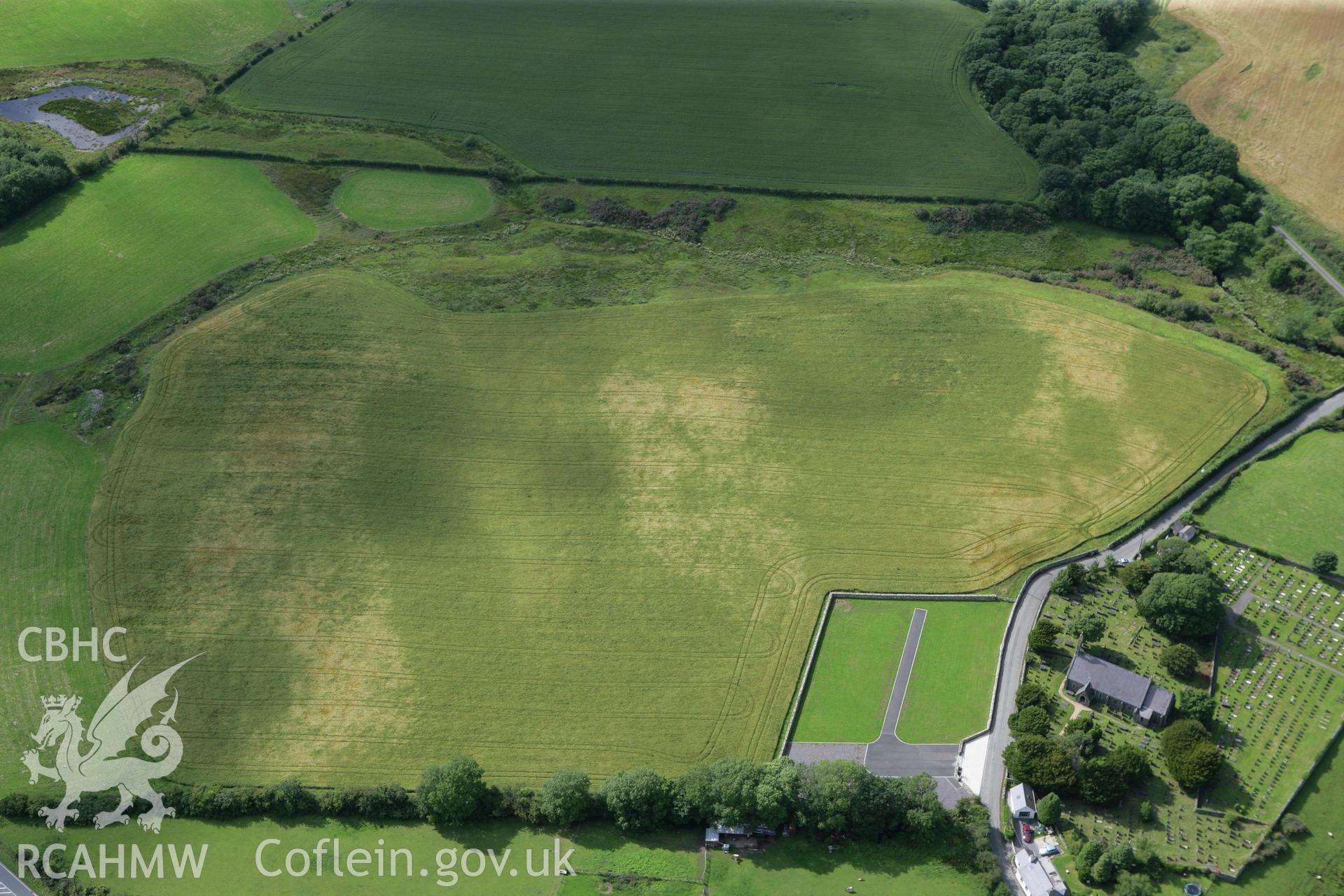 RCAHMW colour oblique photograph of St Cedol's Church, cropmarks (non-archaeological) to south-west of. Taken by Toby Driver on 20/07/2011.