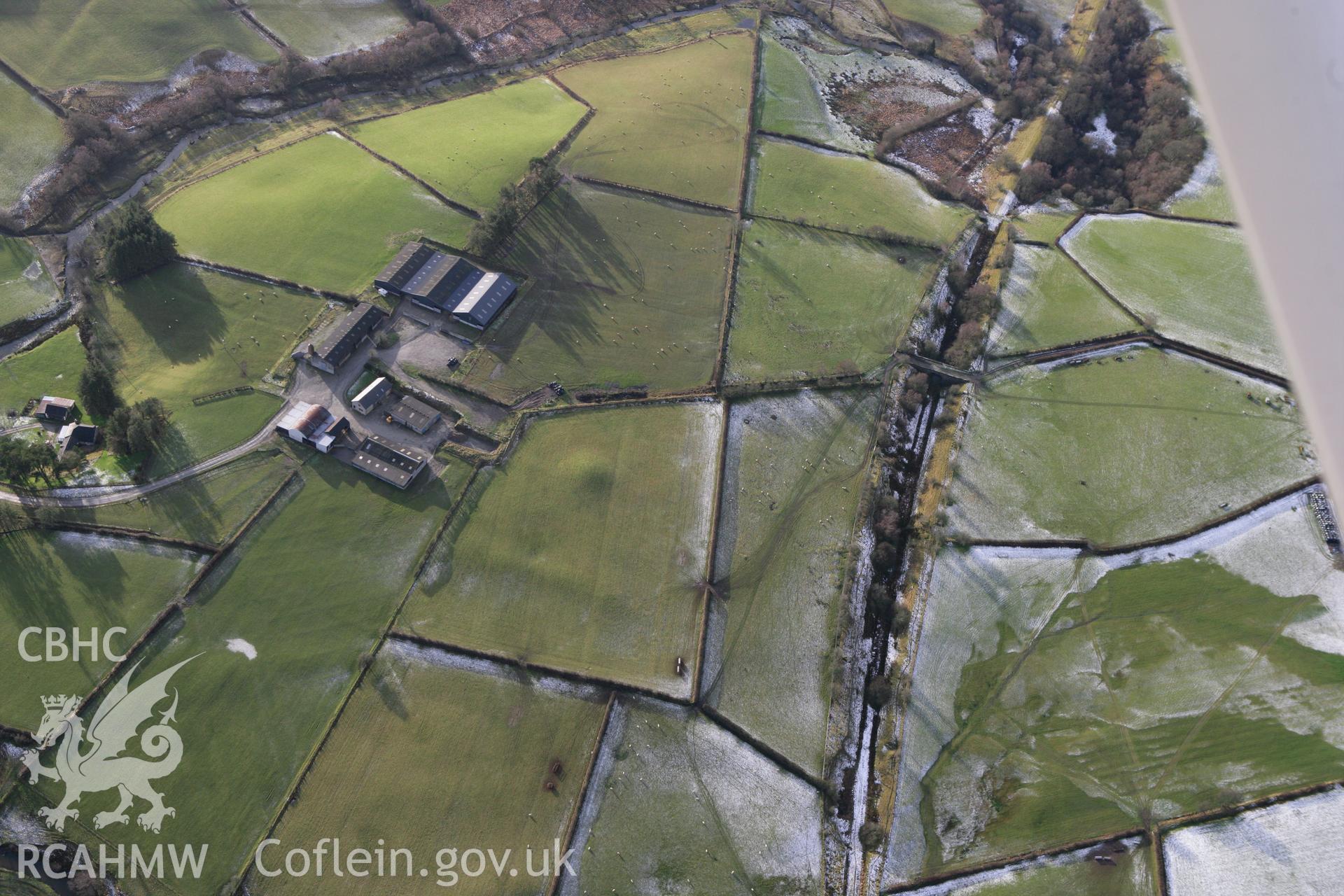 RCAHMW colour oblique photograph of Crugyn tumulus, St Harmon, with agger of Roman road to west. Taken by Toby Driver on 18/12/2011.