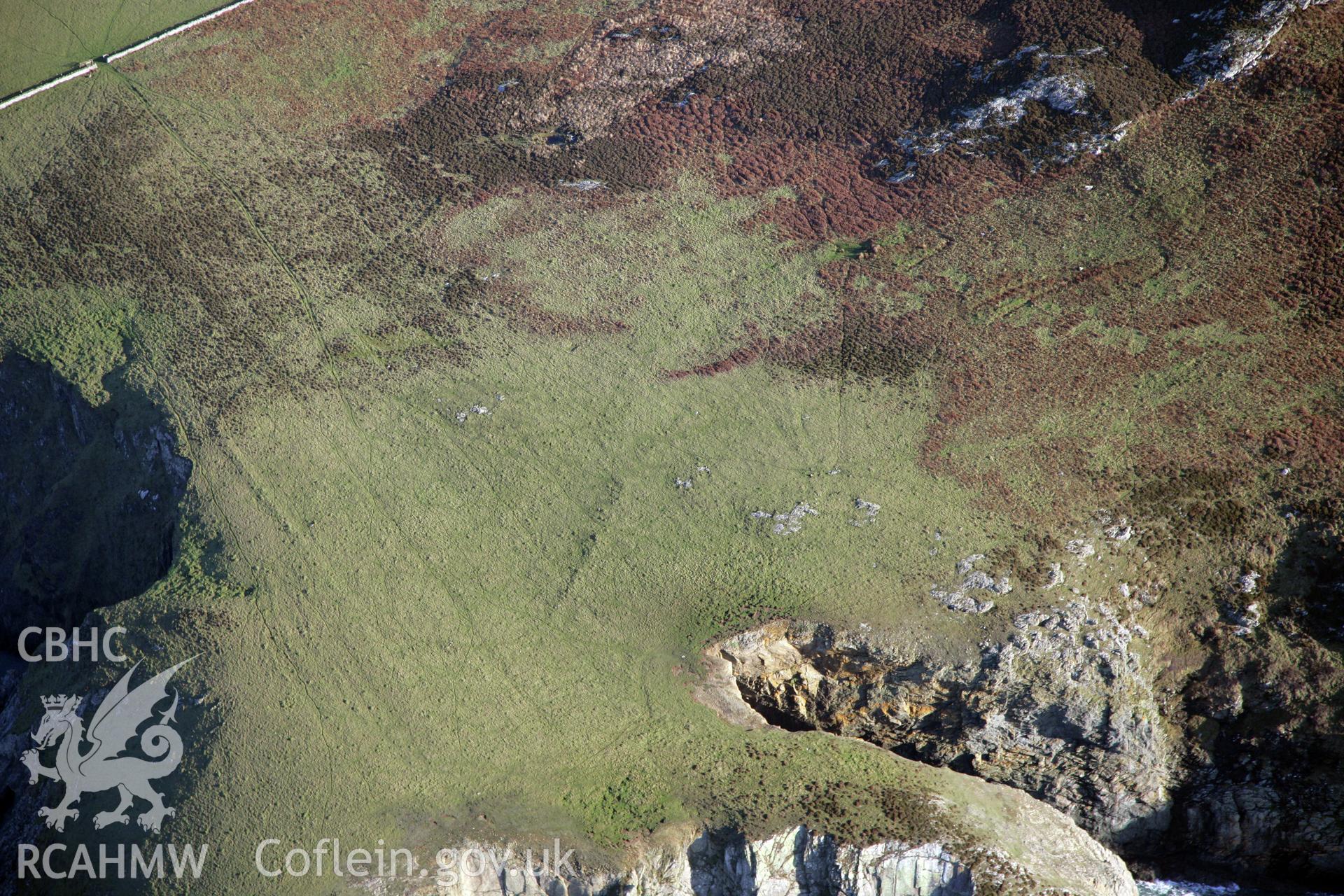 RCAHMW colour oblique photograph of Trwyn Draen-Du enclosure, cultivation features and other features, viewed from the west. Taken by O. Davies & T. Driver on 22/11/2013.