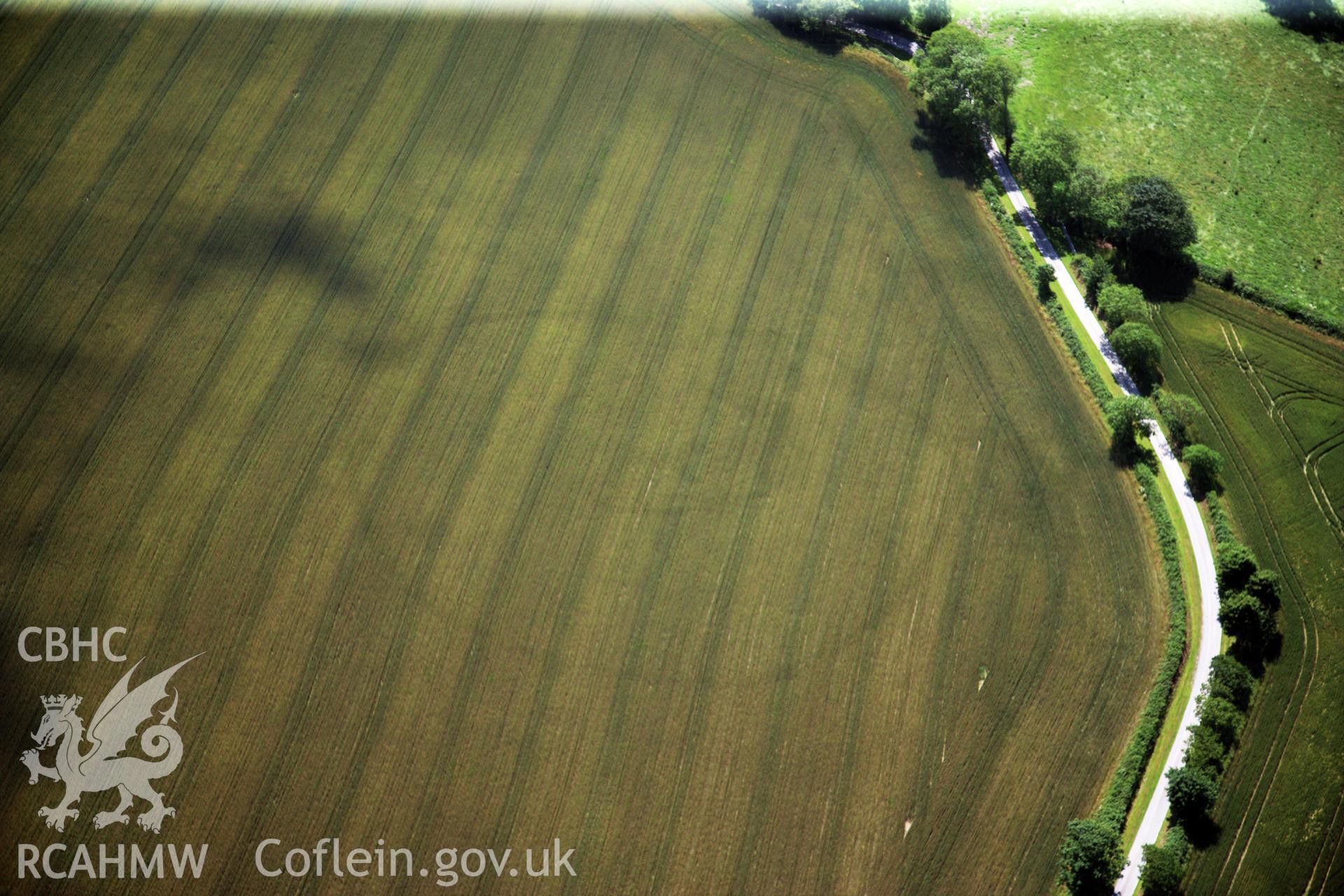 RCAHMW colour oblique photograph of Cawrence Cropmark Enclosure. Taken by Toby Driver and Oliver Davies on 28/06/2011.