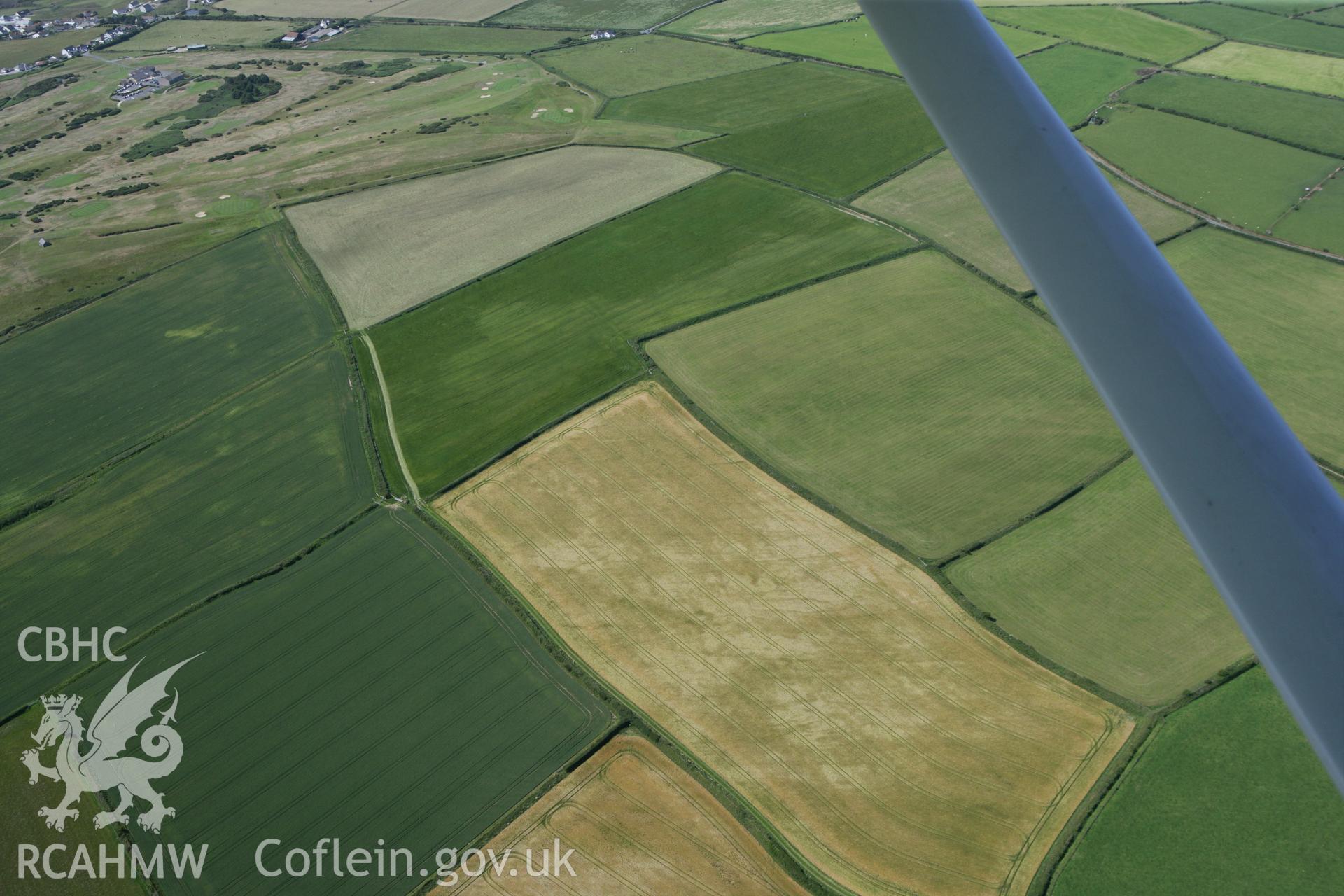 RCAHMW colour oblique photograph of Enclosure, Towyn Warren. Taken by Toby Driver and Oliver Davies on 28/06/2011.