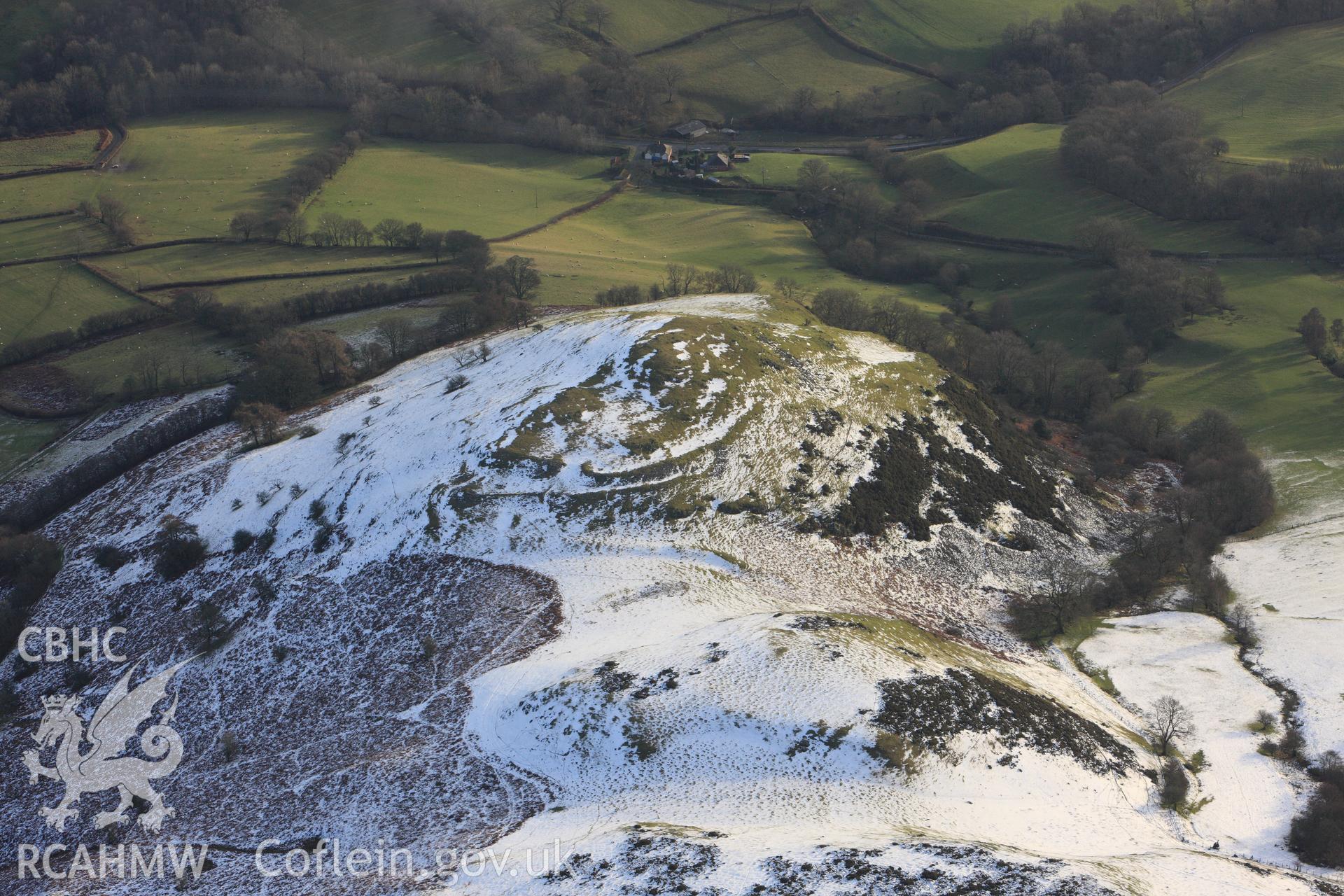 RCAHMW colour oblique photograph of Caer Einion hillfort, with melting snow. Taken by Toby Driver on 18/12/2011.