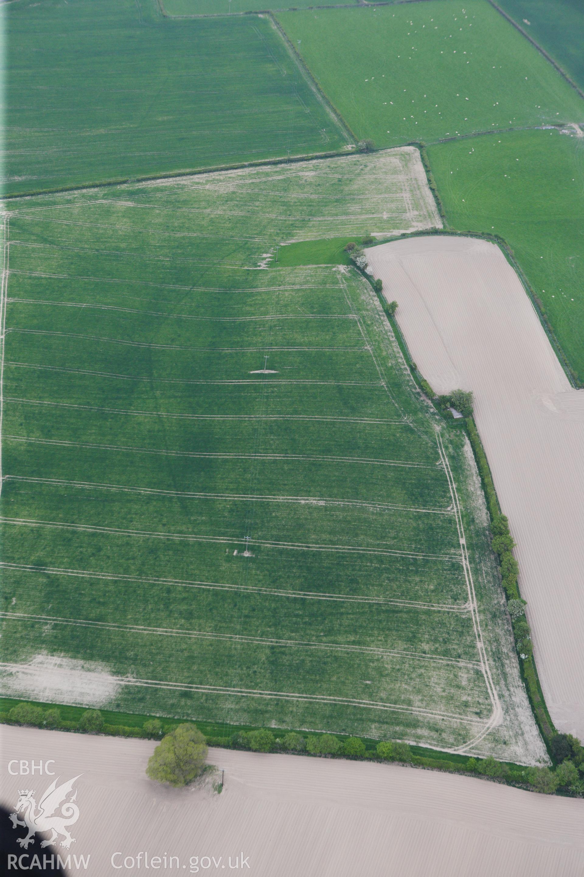 RCAHMW colour oblique photograph of Womaston Neolithic Causewayed enclosure. Taken by Toby Driver on 26/04/2011.